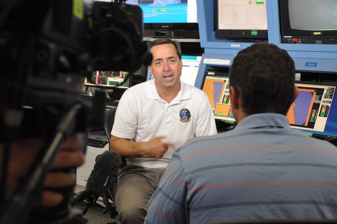 Mike McAleenan, a launch weather officer with the 45th Weather Squadron, is interviewed by The Weather Channel June 18 at Cape Canaveral Air Force Station, Fla. for a story that will air on The Weather Channel July 12 during Space Week. During the interview, Mr. McAleenan said, "The weather squadron has a very unique, very challenging mission, and it's very exciting." (U.S. Air Force Photo/Staff Sgt. Erin Smith)