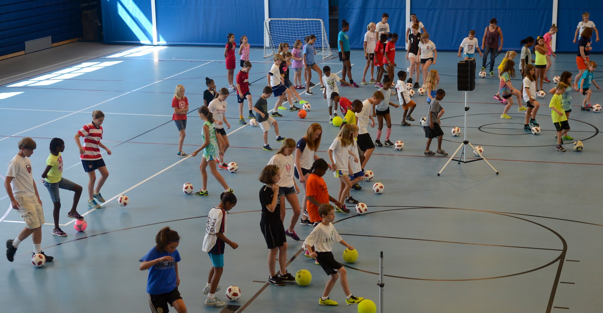 Children practice ball control during an exercise directed by Mia Hamm, former soccer Olympian, June 15, 2013, at Fort Eustis, Va. Prior to the event, attendees were given a soccer ball, signing card and T-shirt for Hamm and her colleagues to sign. (U.S. Air Force photo by Airman 1st Class Austin Harvill/Released)