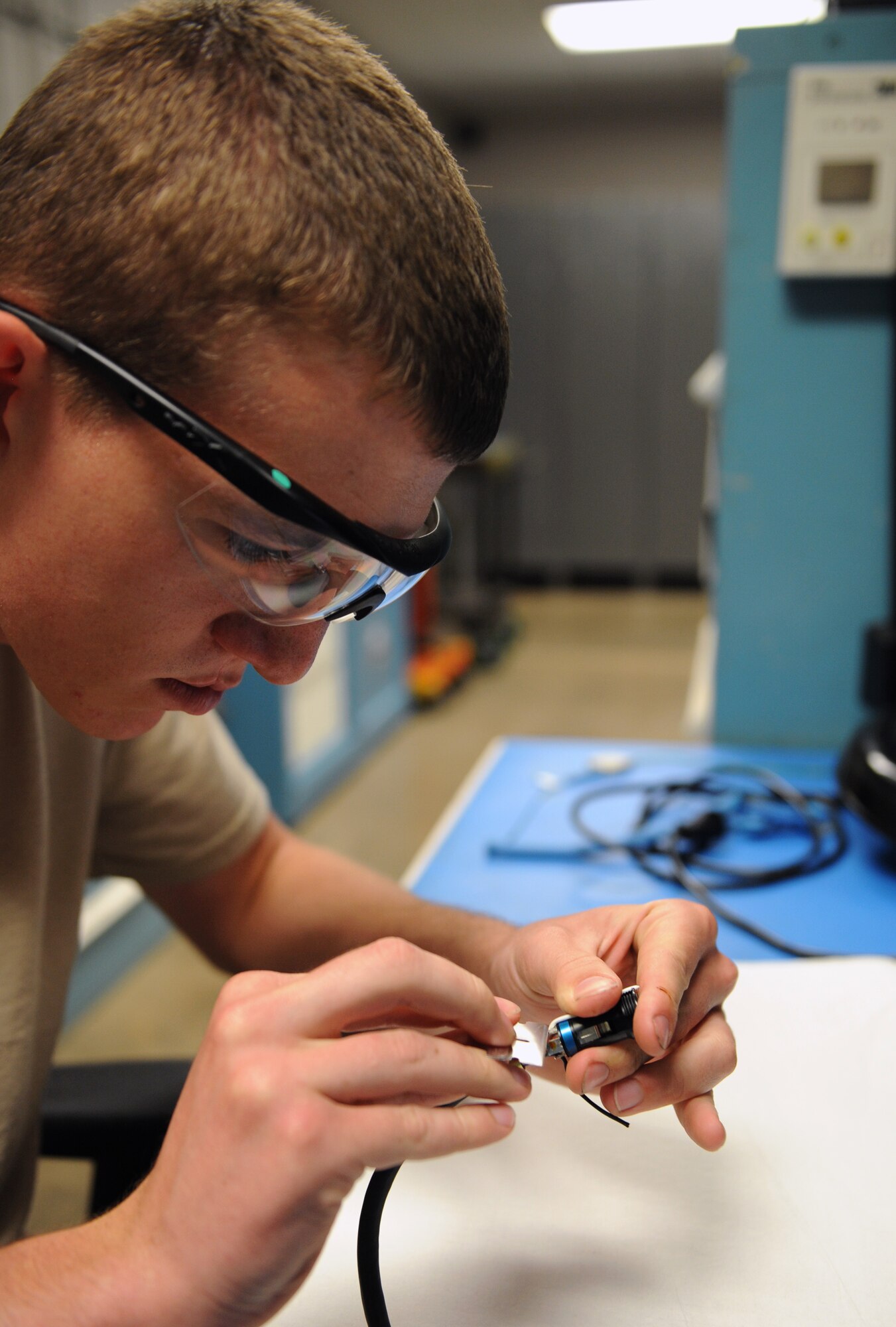 Airman 1st Class Ethan Meyers, 2nd Maintenance Squadron communication navigation mission systems apprentice, solders a connector to a communication cord on Barksdale Air Force Base, La., June 18, 2013. The communication cords are used by aircrew and ground personnel. When a communication cord becomes faulty during an operation on the flightline, avionics Airmen will either fix or solder a new one on the spot. (U.S. Air Force photo/Airman 1st Class Benjamin Gonsier)
