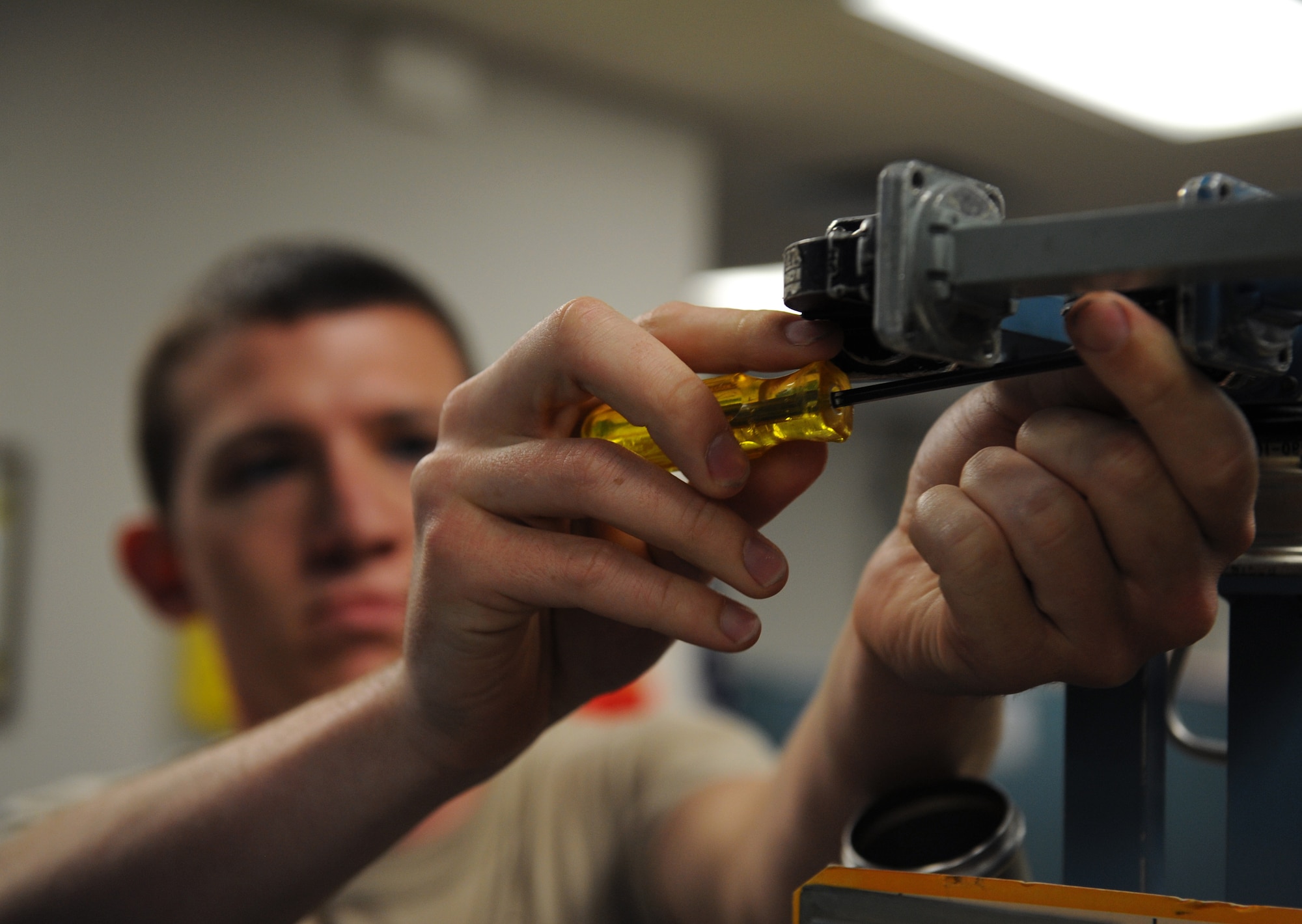 Airman 1st Class Ethan Meyers, 2nd Maintenance Squadron communication navigation mission systems apprentice, removes a wave guide from avionics equipment on Barksdale Air Force Base, La., June 18, 2013. Because avionics equipment require more power to run, wave guides are used instead of wires. (U.S. Air Force photo/Airman 1st Class Benjamin Gonsier)
