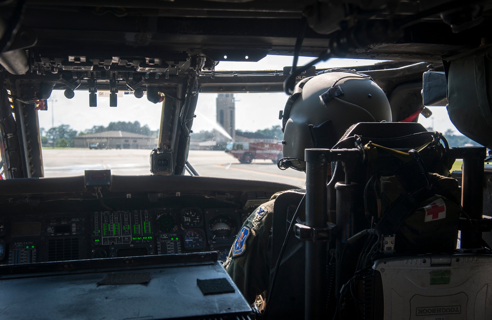 U.S. Air Force Col. Billy D. Thompson, 23d Wing commander, taxis an HH-60G Pave Hawk under streams of water from fire trucks during his final flight at Moody Air Force Base, Ga., June 14, 2013. Taxiing under the streams of water from fire trucks is a customary event at the end of a pilot’s final flight. (U.S. Air Force photo by Senior Airman Jarrod Grammel/Released)
