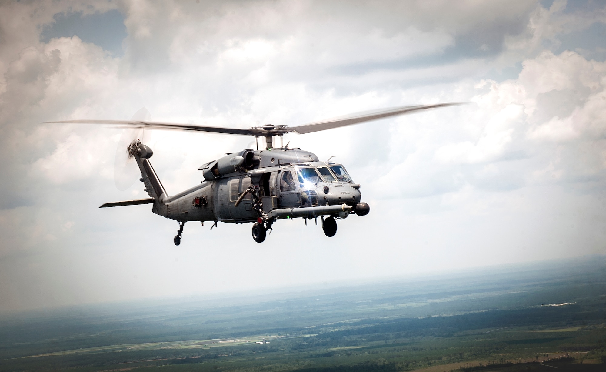 An HH-60G Pave Hawk piloted by U.S. Air Force Col. Billy D. Thompson, 23d Wing commander, flies in formation during his final flight at Moody Air Force Base, Ga., June 14, 2013. Thompson is a command pilot with 2,700 flight hours. (U.S. Air Force photo by Senior Airman Jarrod Grammel/Released)
