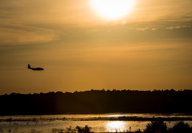 An Air Force Reserve aircrew flying a C-130 Hercules assigned to the 910th Airlift Wing, Youngstown Air Reserve Station, Ohio, performs aerial spraying of mosquitos June 15, 2013, over Joint Base Charleston – Weapons Station, S.C. The insecticide the unit uses is mixed with water to dilute the product. (U.S. Air Force photo/Senior Airman Dennis Sloan)