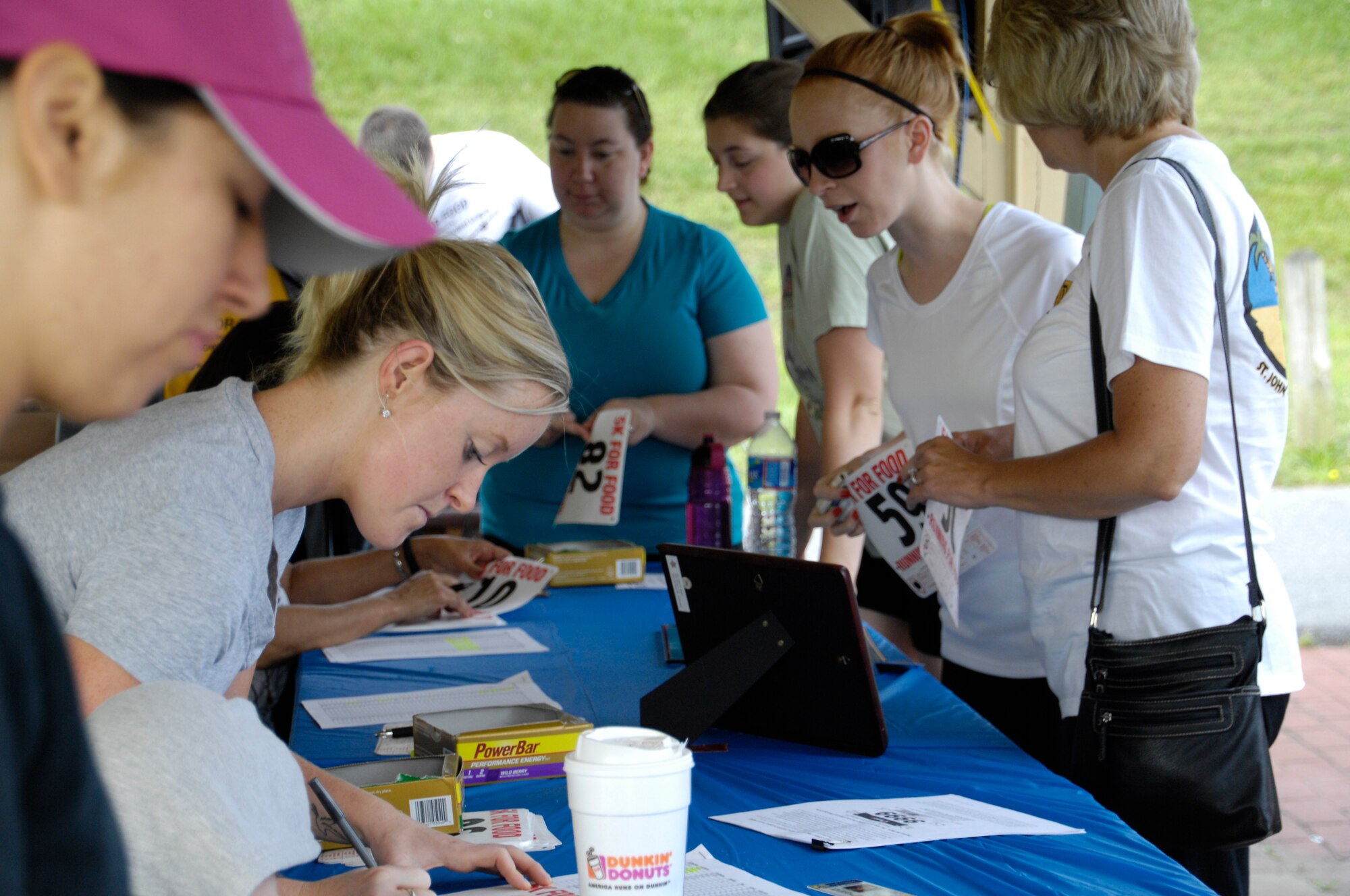 Volunteers from the 193rd Special Operations Wing register participants for the 2013 5K for food, held June 16 at City Island in Harrisburg, Pa. The event raised more than $2,500 for the Central Pa. Food Bank. (U.S. Air National Guard photo by Staff Sgt. Susan Penning/Released)