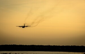 An Air Force Reserve aircrew flying a C-130 Hercules assigned to the 910th Airlift Wing, Youngstown Air Reserve Station, Ohio, performs aerial spraying of mosquitos June 15, 2013, over Joint Base Charleston – Weapons Station, S.C. The insecticide the unit uses is mixed with water to dilute the product. (U.S. Air Force photo/Senior Airman Dennis Sloan)
