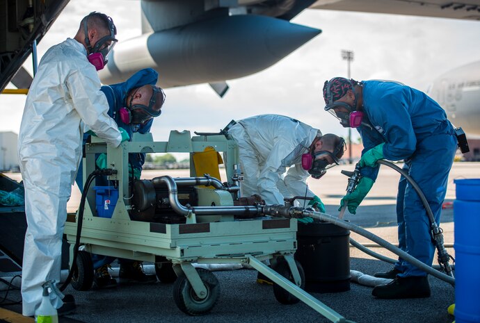 The 910th Airlift Wing spray maintainers, Youngstown Air Reserve Station, Ohio, transfer insecticide from barrels into a machine that filters it through to tanks within the aircraft for aerial spraying of mosquitos June 15, 2013, at Joint Base Charleston – Air Base, S.C. The spray crew is the only one of its kind in the Air Force, assisting multiple bases year-round with their specific area of expertise. Spraying for mosquitos was conducted over the JB Charleston – Weapons Station.  (U.S. Air Force photo/Senior Airman Dennis Sloan)