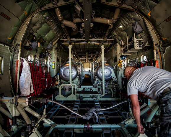 Master Sgt. Steven Feliz, 910th Airlift Wing spray maintainer, Youngstown Air Reserve Station, Ohio, preps the Modular Aerial Spray System on a C-130 Hercules for an aerial spray mission to lower mosquito counts June 15, 2013, at Joint Base Charleston – Air Base,  S.C. Spraying for mosquitos was conducted over the JB Charleston – Weapons Station. The MASS is maintained by the 910th AW support personnel. (U.S. Air Force photo/Senior Airman Dennis Sloan)