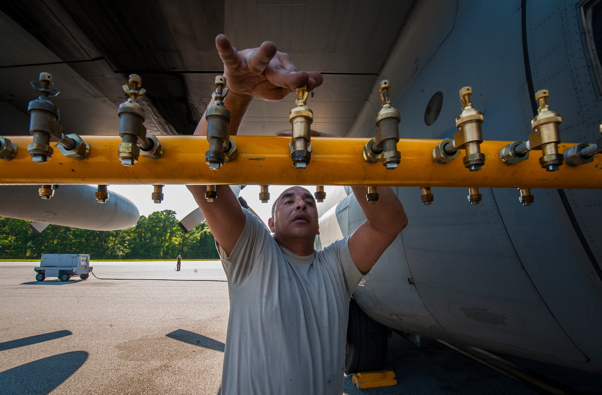 Master Sgt. Steven Feliz, 910th Airlift Wing spray maintainer, Youngstown Air Reserve Station, Ohio, opens the nozzles of a Modular Aerial Spray System on a C-130 Hercules June 15, 2013, at Joint Base Charleston – Air Base, S.C. Spraying for mosquitos was conducted over the JB Charleston – Weapons Station. The MASS is maintained by the 910th AW support personnel. (U.S. Air Force photo/Senior Airman Dennis Sloan)