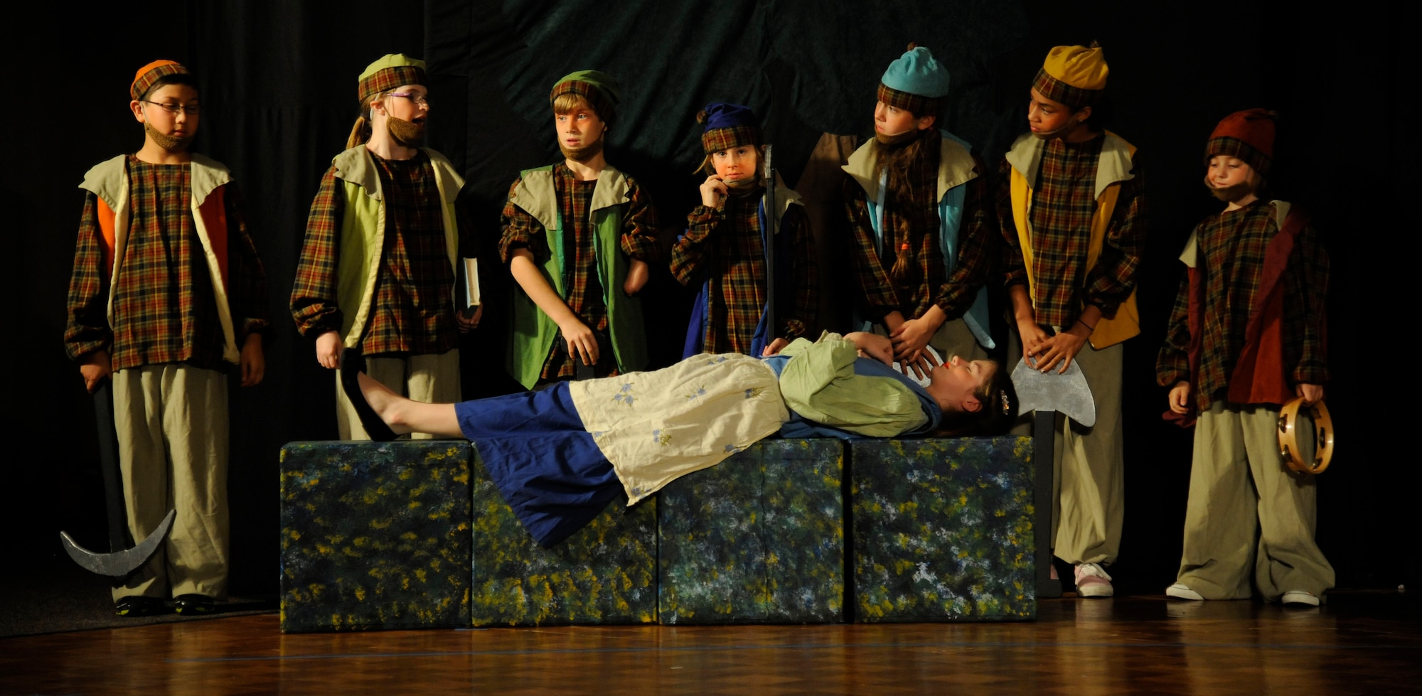 The seven dwarves lift a spell placed on Snow White by the Queen during the Missoula Children's Theatre dinner play of "Snow White" on Barksdale Air Force Base, La., June 14, 2013. For more than 40 years, the Missoula Children's Theatre has cast children as cast members and used the performing arts to teach them life skills. (U.S. Air Force photo/Airman 1st Class Andrew Moua)