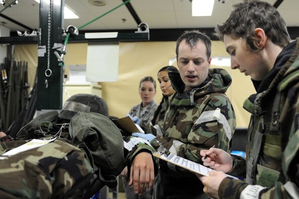 Airmen from the 35th Medical Group assess a simulated patient’s condition and collect personal information during an Operational Readiness Exercise at Misawa Air Base, Japan, June 17, 2013. Air Force medics use exercises to hone their ability to provide combat casualty care in deployed environments. (U.S. Air Force photo by Airman 1st Class Kia Atkins)