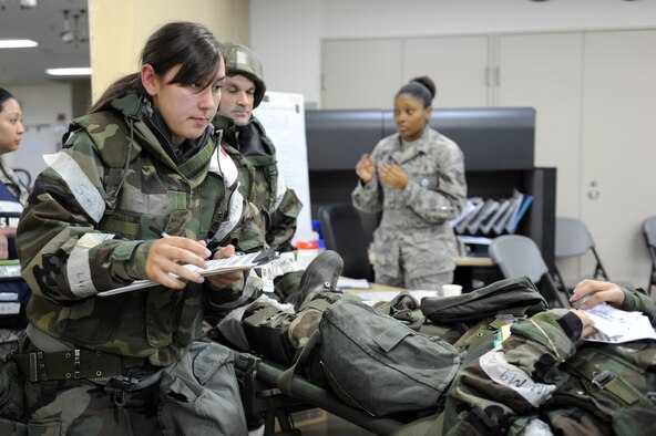 U.S. Air Force Airman 1st Class Aubrey George, left, 35th Medical Support Squadron outpatient records technician, collects a simulated patient’s information after they were transported to the 35th Medical Group during an Operational Readiness Exercise at Misawa Air Base, Japan, June 17, 2013. Medics work hard to take advantage of the ‘golden hour’, first hour after an attack. Treatment given to a trauma patient within that time increases the member’s chances of making a full recovery. (U.S. Air Force photo by Airman 1st Class Kia Atkins)