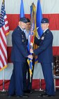 Col. Lance Landrum took the reins of the 388th Fighter Wing during a Change of Command ceremony June 14, 2013, at Hill Air Force Base. From right, Landrum receives the wing guidon from Lt. Gen. Robin Rand, Commander, 12th Air Force, Air Combat Command, and Commander, Air Forces Southern, U.S. Southern Command, who presided over the ceremony while Chief Master Sgt. Daniel McGuire, 388th command chief, looks on. (U.S. Air Force photo by Alex Lloyd/Released).