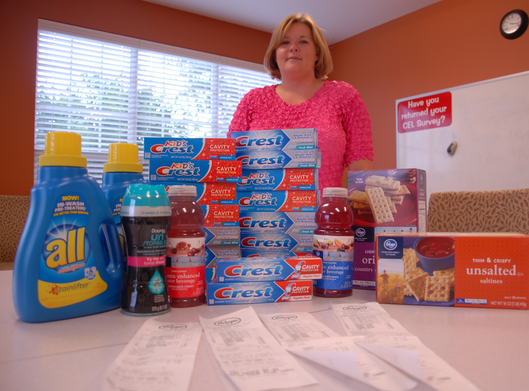 Heather Phillips, a Little Rock Air Force Base Welcome Center leasing agent and couponer, stands behind the groceries she paid only $15 for. Phillips bought 17 tubes of toothpaste for 46 cents at Kroger. Without her coupons her total would have been about $35; she saved more than half the money she spent. (U.S. Air Force photo by Senior Airman Regina Agoha) 