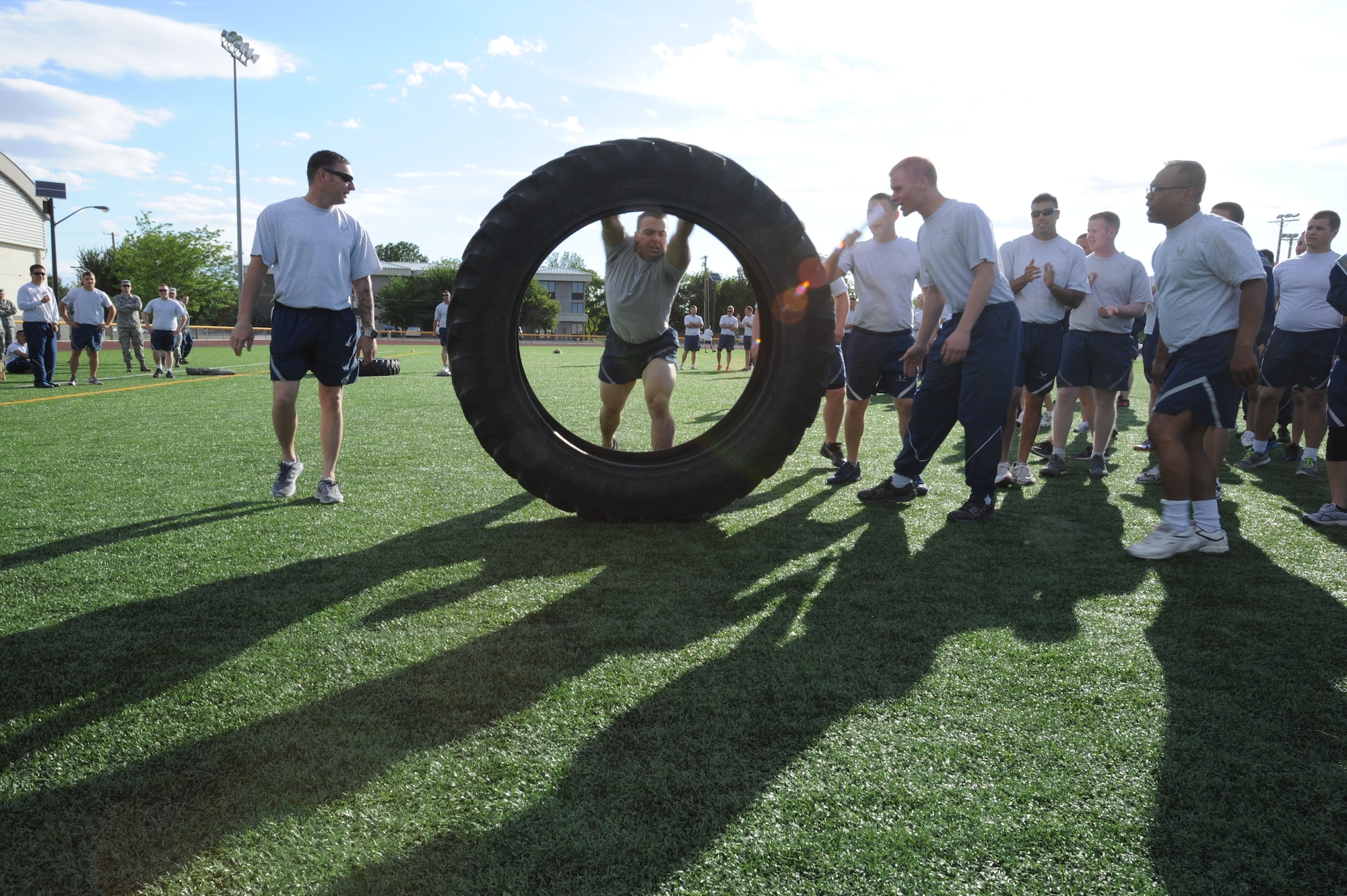 While participating in the Gunfighter Challenge, an Airman turns flips a tire during the physical fitness portion of the challenge June 13, 2013, at Mountain Home Air Force Base, Idaho. The teams raced each other in feats of strength and endurance. (U.S. Air Force Photo by Airman 1st Class Malissa Lott/Released)
