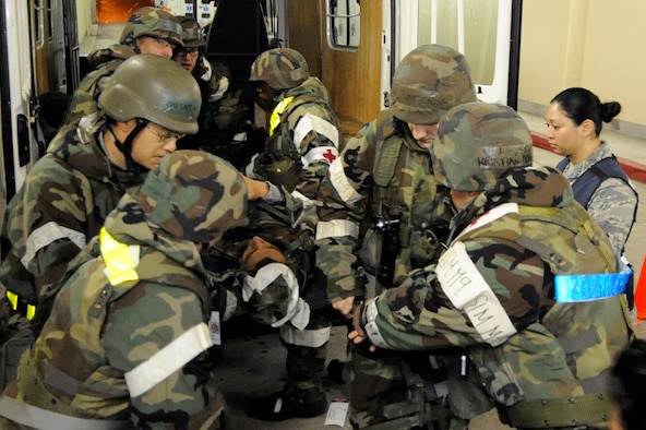 Airmen from the 35th Medical Group pull a simulated casualty out of an ambulance during an Operational Readiness Exercise at Misawa Air Base, Japan, on June 17, 2013.  OREs are used to evaluate the operational capability and effectiveness of the wing during contingency operations. (U.S. Air Force photo by Airman 1st Class Kaleb Snay)