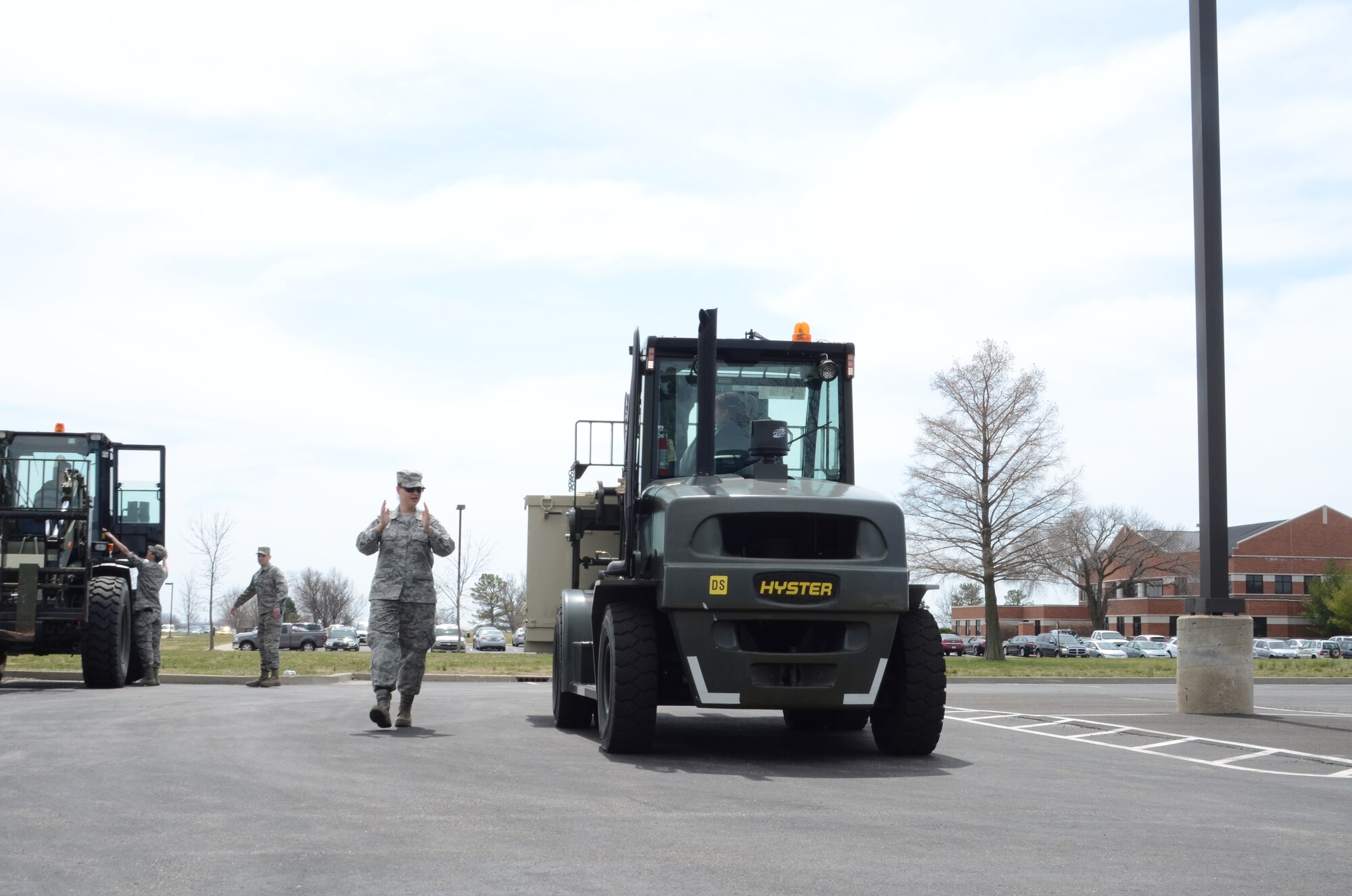 Tech Sgt. Nichole Peterson, a Services Technician with the 126th Force Support Squadron, directs forklift training during the 126 FSS field training exercise at Scott AFB, Ill., April 6, 2013. The Illinois Air National Guard unit conducted training with both active duty and other National Guard units during the April unit training assembly. (National Guard photo by Airman 1st Class Elise Stout)