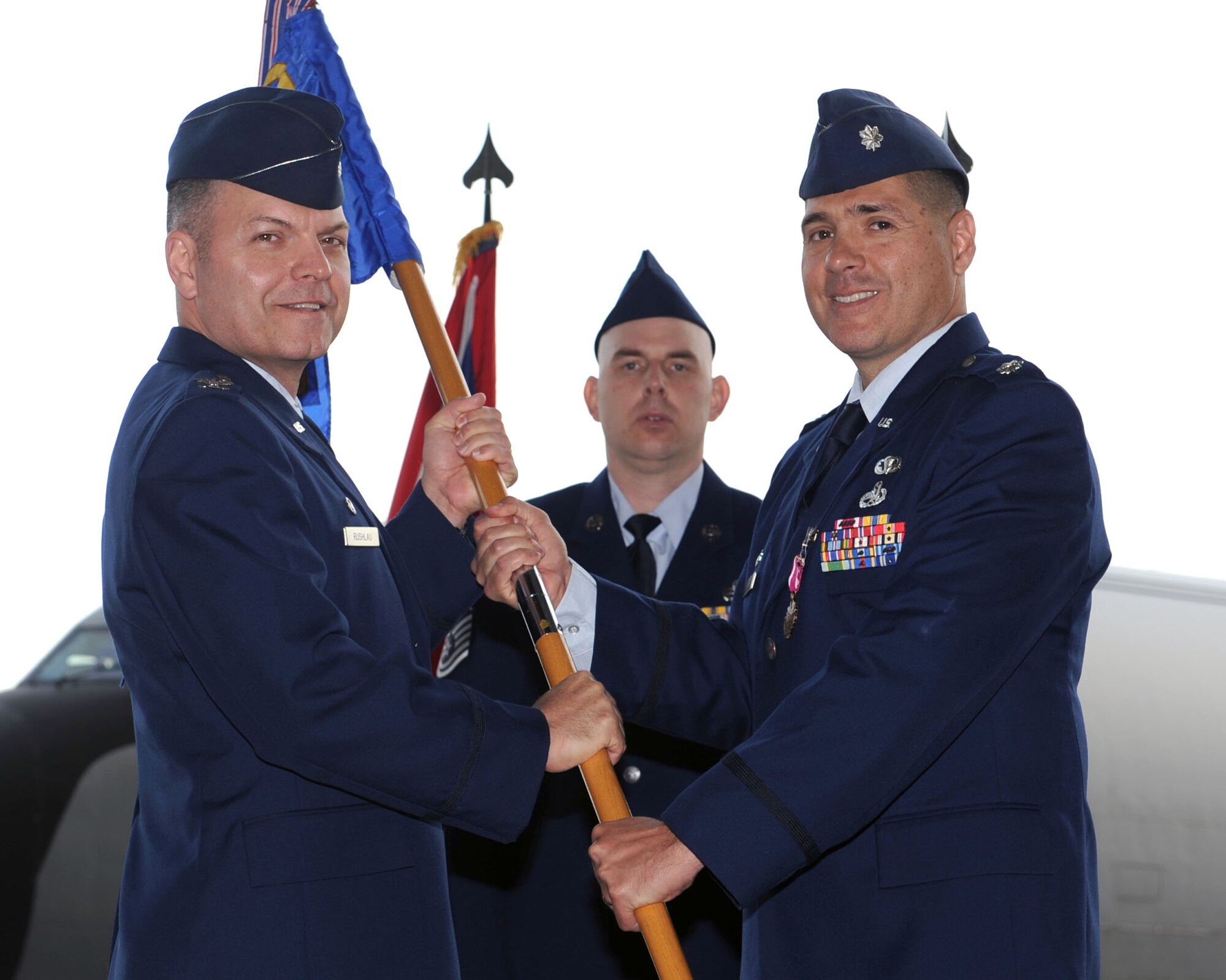 From right, Lt. Col. Joseph Giuliani, outgoing 100th Aircraft Maintenance Squadron commander, relinquishes the 100th AMXS guidon to Col. Joseph Rushlau, 100th Maintenance Group commander, during the 100th AMXS change of command ceremony June 18, 2013, on RAF Mildenhall, England. While in command of the 100th AMXS, Giuliani led and supervised 220 maintainers across six career fields and directed quality on-aircraft maintenance for 15 KC-135 Stratotanker aircraft. (U.S. Air Force photo by Airman 1st Class Preston Webb/Released)