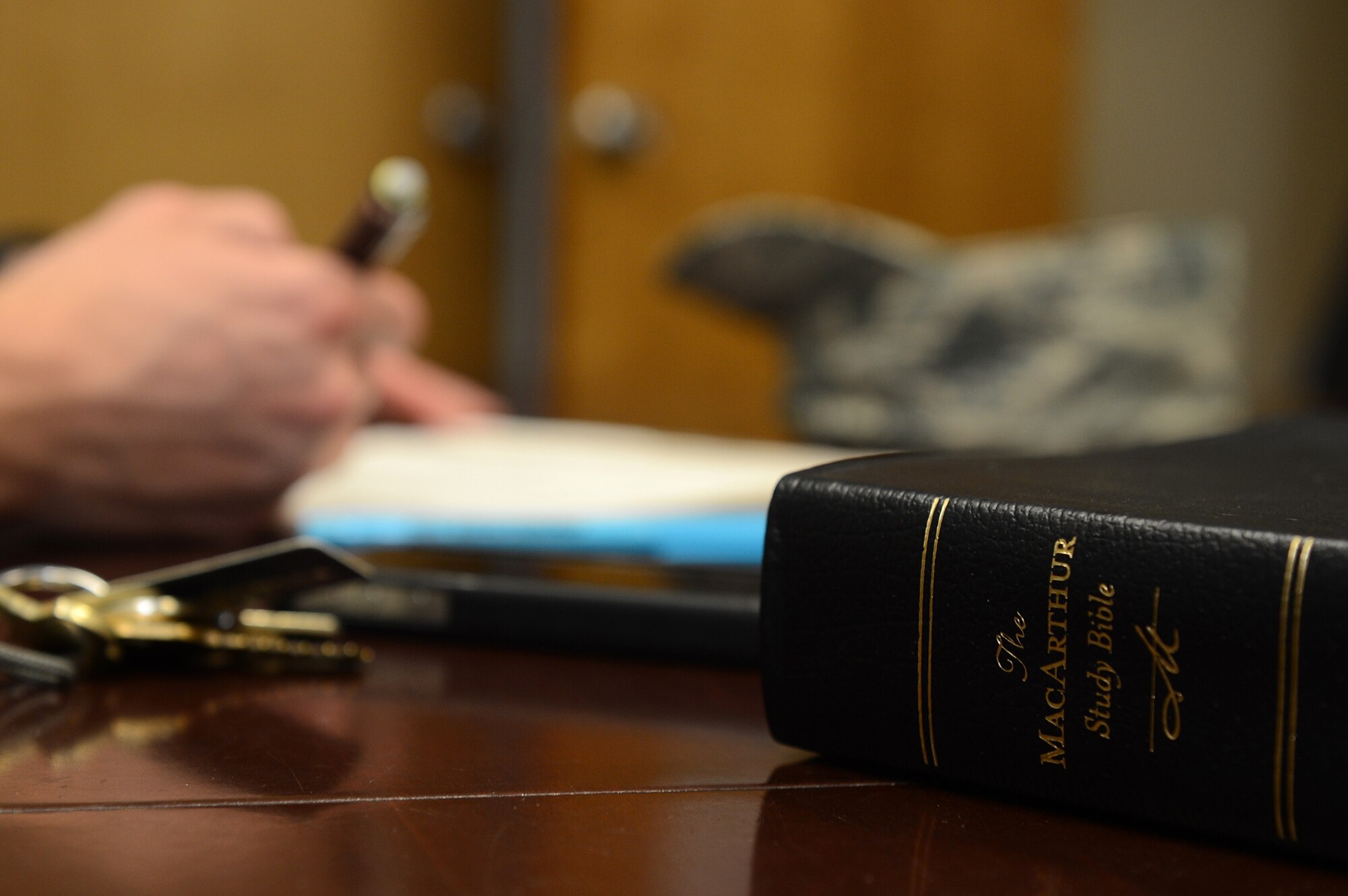 Staff Sgt. Nathan Coley, 20th Communications Squadron ground radar systems supervisor, takes notes after reading his MacArthur study bible, Shaw Air Force Base, S.C., June 14, 2013. Coley attributes his success in life and as an Airman to the teachings and principles found within the bible.  (U.S. Air Force photo by Airman 1st Class Daniel Blackwell/Released)