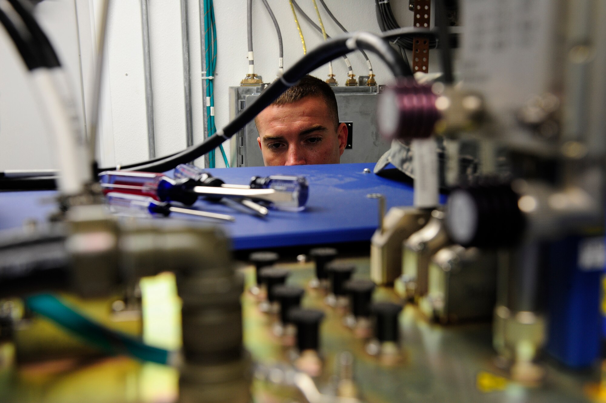 Staff Sgt. Nathan Coley, 20th Communications Squadron ground radar systems supervisor, ensures all cable fittings are in place on the Monopulse Secondary Surveillance Radar at Shaw Air Force Base, S.C., June 14, 2013. Coley helps maintain and repair radar surveillance equipment at Shaw so those on the ground can have eyes in the sky. (U.S. Air Force photo by Airman 1st Class Daniel Blackwell/Released)