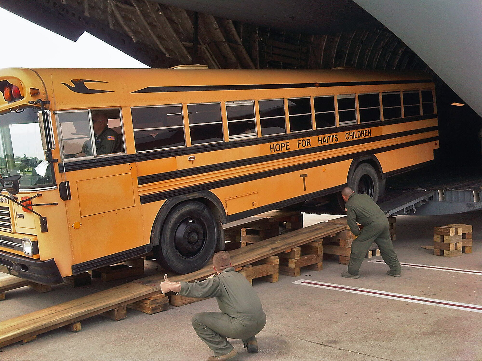 Airmen of the 732nd Airlift Squadron and 514th Aircraft Maintenance Squadron spent Fathers Day weekend performing a humanitarian mission to Haiti. The Airmen transported one school bus and five pallets of pinto beans and corn grits from Charleston, S.C., to Hait's Port-au-Prince International Airport as part of a Denton cargo mission. Through the Denton program, humanitarian cargo that has been donated by private organizations can fly on Air Force aircraft on a space-available basis. The Denton missions also serve by providing training opportunities to mobility Airmen. (U.S. Air Force photo)