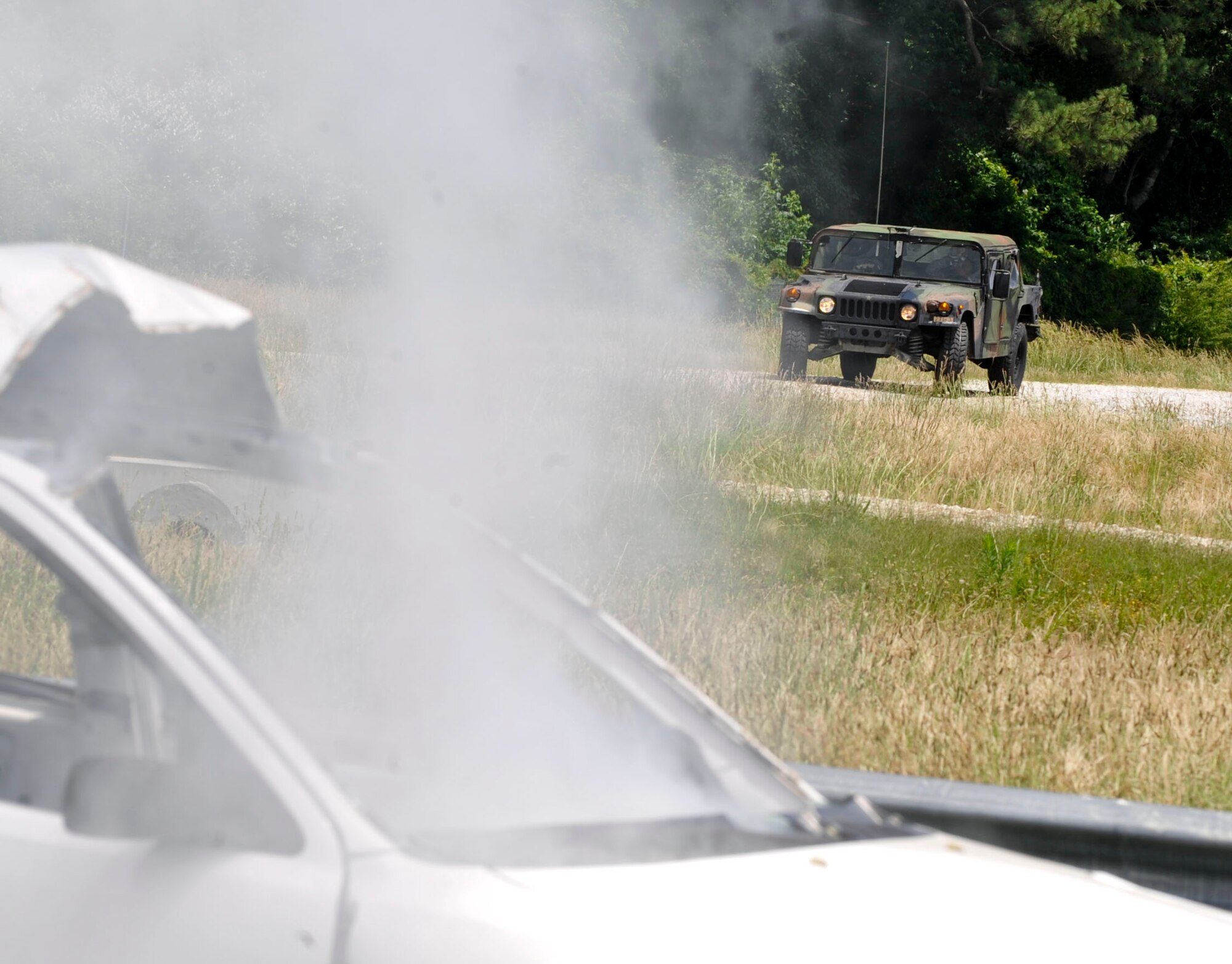 Members of the 271st Movement Control Team respond to a simulated vehicle-born improvised explosive device during a counter-IED training class at Naval Weapons Station Yorktown, Va., June 13, 2013. The 271st MCT took the class to prepare for an upcoming deployment later this year. (U.S. Air Force photo by Staff Sgt. Wesley Farnsworth / Released)
