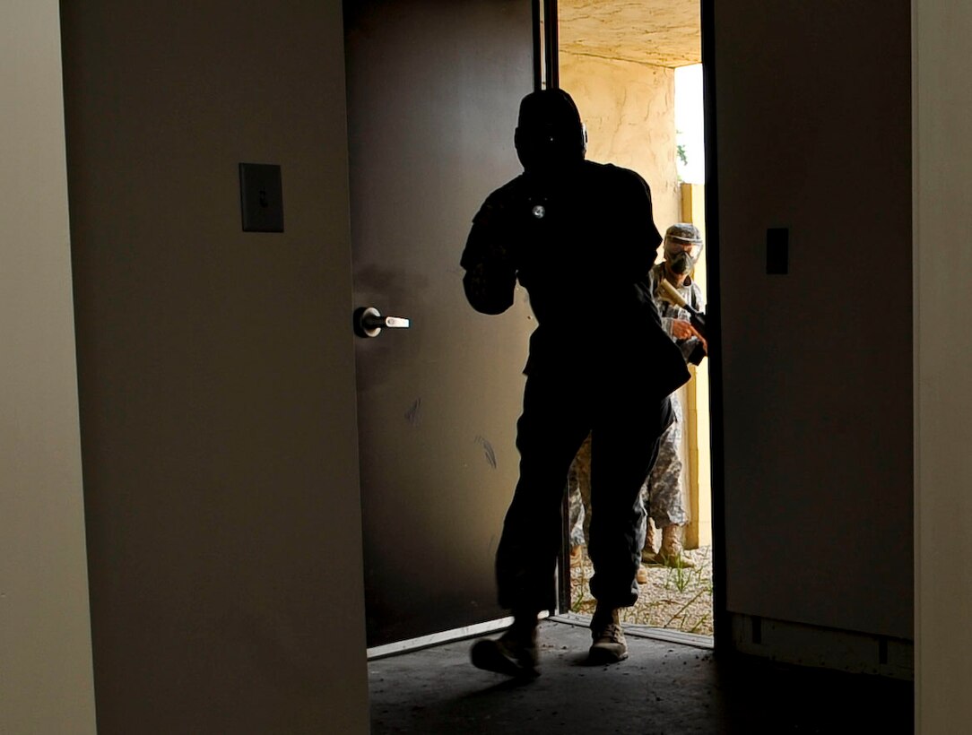 Soldiers clear a building where they suspect simulated insurgents may be hiding during a three-day counter improvised explosive device class at Naval Weapons Station Yorktown, Va., June 13, 2013. The 271st MCT is preparing for an upcoming deployment later this year. (U.S. Air Force photo by Staff Sgt. Wesley Farnsworth / Released)