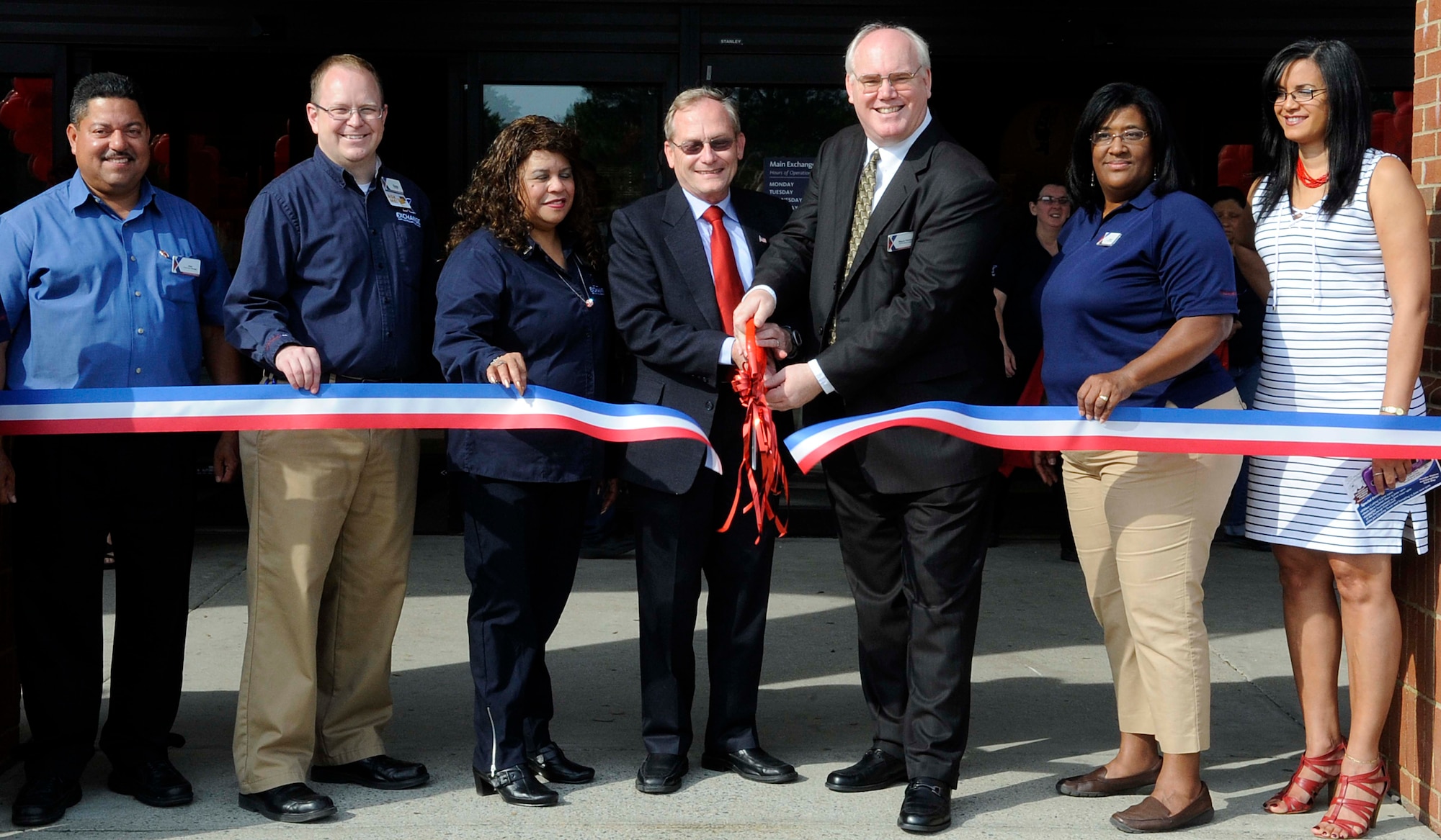 (From left) Dan Flores, Exchange food court manager; Dale Killip, Exchange Sales & Merchandise manager; Victoria Smith, Exchange store manager; Keith Morrow, 733rd Mission Support Group deputy commander; Wayne Hansen, Joint Base Langley-Eustis Exchange general manager; Cheryl Hollis, Military Clothing Sales manager; and Ivelisse Solazayas, JBLE Services Business manager, cut the ribbon during the Exchange grand opening ceremony at Fort Eustis, Va., June 13, 2013. The updated Exchange features three new restaurants and in the main store, the outdoor living section has expanded, and boasts a more environmentally controlled, enclosed area. (U.S. Air Force photo by Staff Sgt. Dana Hill/Released)