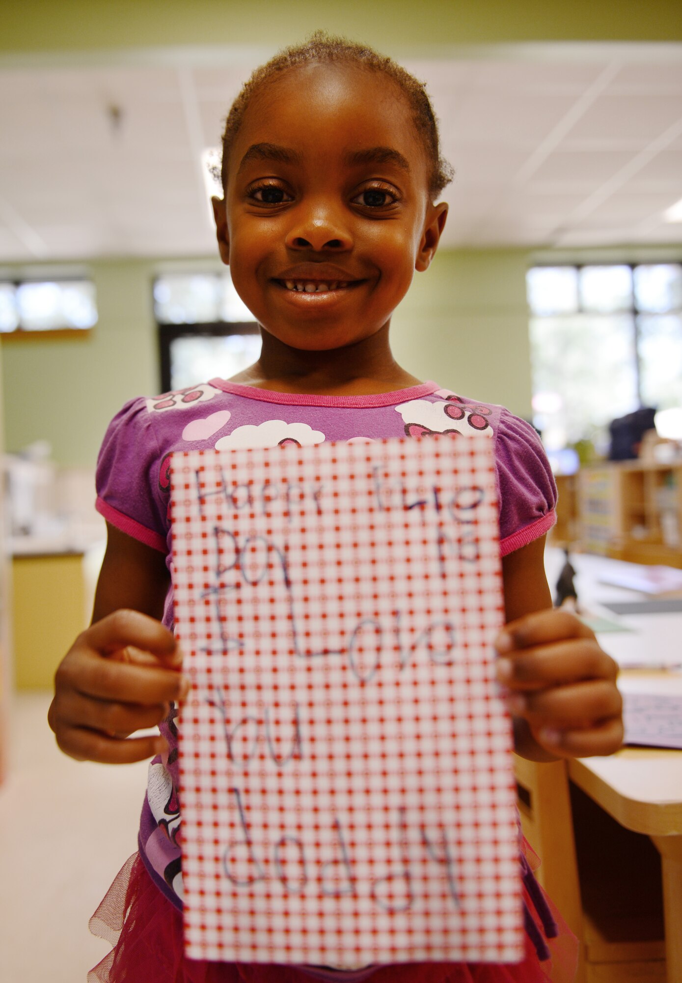 Maya Simpson, daughter of U.S. Air Force Tech. Sgt. Arthur Simpson, 20th Civil Engineer Squadron electronics system craftsman, and Tech. Sgt. Jessica Simpson, 20th Fighter Wing NCOIC equal opportunity, made a card for her father and says that she loves when her dad makes her giggle a lot, Shaw Air Force Base, S.C., June 13, 2013. This Sunday, June 16 was Father’s Day a celebration honoring fathers and celebrating fatherhood, paternal bonds and the influence of fathers in society. (U.S. Air Force photo by Senior Airman Tabatha Zarrella/Released)