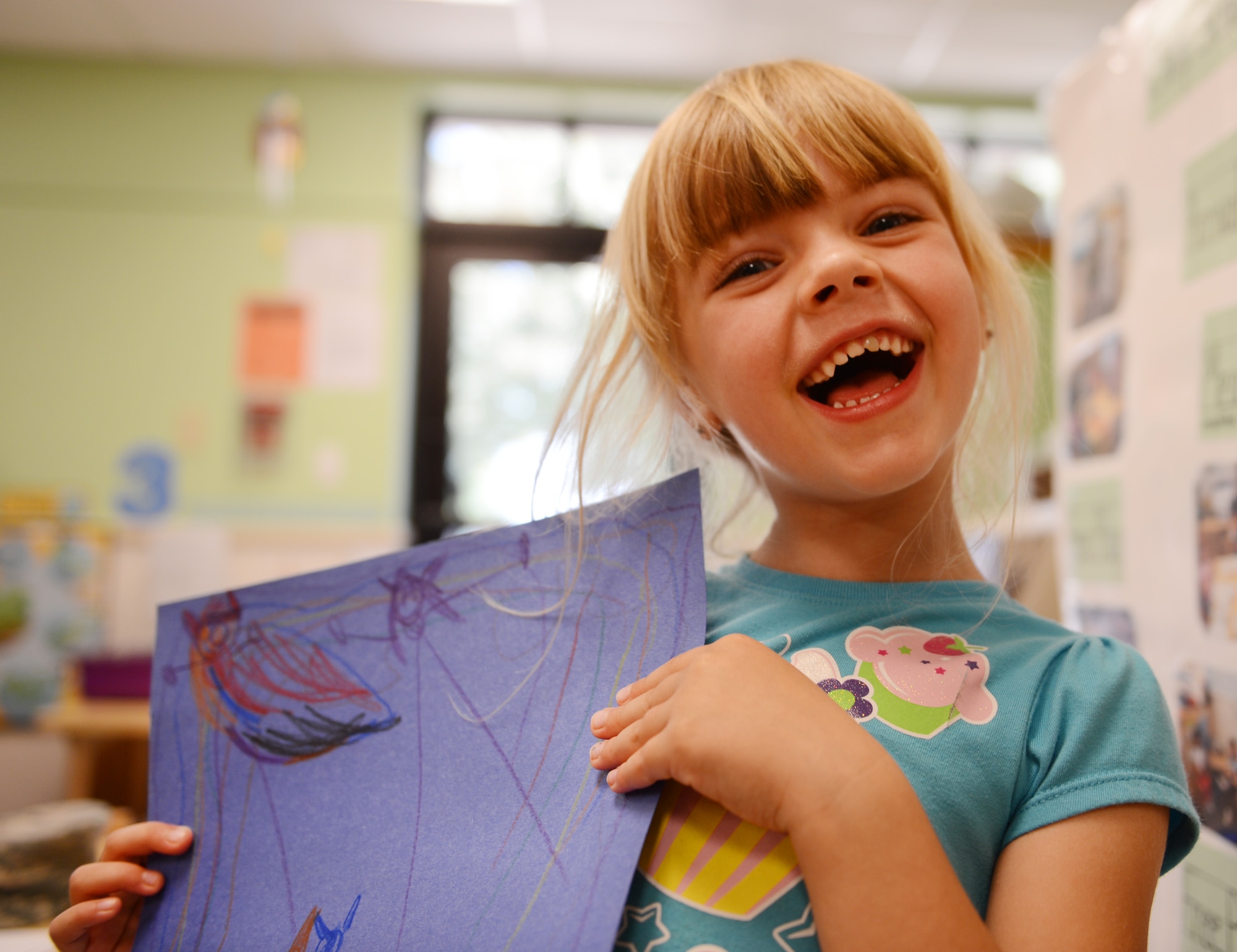 Sophia Yarbrough, daughter of U.S. Air Force Staff Sgt. Natalie Yarbrough, 20th Medical Operations Squadron mental health technician, holds a picture she made of her and her father and said that she loves watching movies with her dad, and when he chases her and tickles her, Shaw Air Force Base, S.C., June 13, 2013. This Sunday, June 16 was Father’s Day a celebration honoring fathers and celebrating fatherhood, paternal bonds and the influence of fathers in society. (U.S. Air Force photo by Senior Airman Tabatha Zarrella/Released)