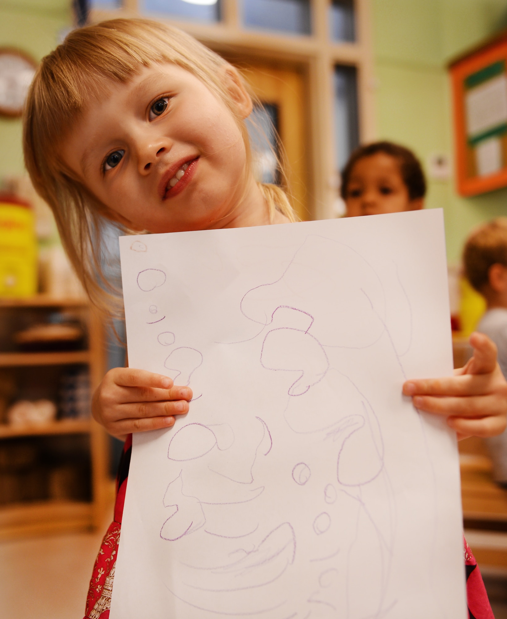 Lilly Lehfeldt, daughter of U.S. Air Force Staff Sgt. Levi Lehfeldt, 20th Component Maintenance Squadron aircraft fuels system craftsman, holds a picture she made for her father and said her favorite thing to do with her dad is when he takes her to the doctor and gets ice cream after, Shaw Air Force Base, S.C., June 13, 2013. This Sunday, June 16 was Father’s Day a celebration honoring fathers and celebrating fatherhood, paternal bonds and the influence of fathers in society. (U.S. Air Force photo by Senior Airman Tabatha Zarrella/Released)