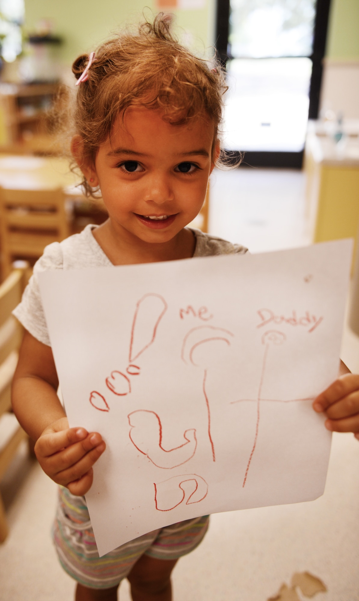 Savannah McGee, daughter of  U.S. Air Force Capt. Toni McGee, 20th Medical Operations Squadron element chief family health, holds a picture she drew for her father and says her favorite thing she likes to do with her dad is watch Bubble Guppies, Shaw Air Force Base, S.C., June 13, 2013. This Sunday, June 16 was Father’s Day a celebration honoring fathers and celebrating fatherhood, paternal bonds and the influence of fathers in society. (U.S. Air Force photo by Senior Airman Tabatha Zarrella/Released)
