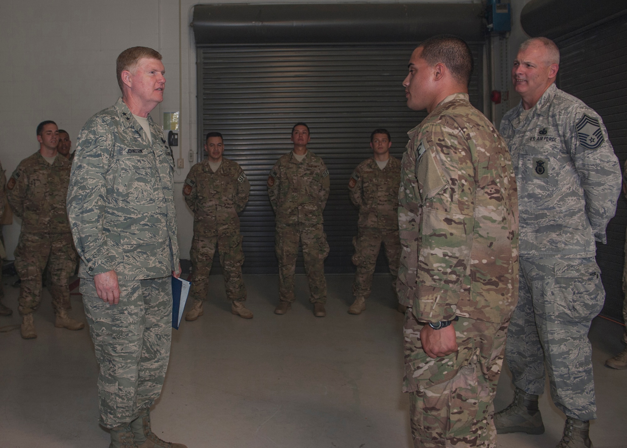U.S. Air Force Maj. Gen. Verle Johnston, New York Air National Guard commander, promotes NYANG Airman Matthew Zuniga, 105th Security Forces Squadron, to airman 1st class during a visit to Moody Air Force Base, Ga., June 12, 2013. Airmen with the 105th SFS and 820th Combat Operations Squadron are partnered in training and deploying together to strengthen the Air Force mission to be combat ready at a moment’s notice. (U.S. Air Force photo by Senior Airman Eileen Meier/Released)
