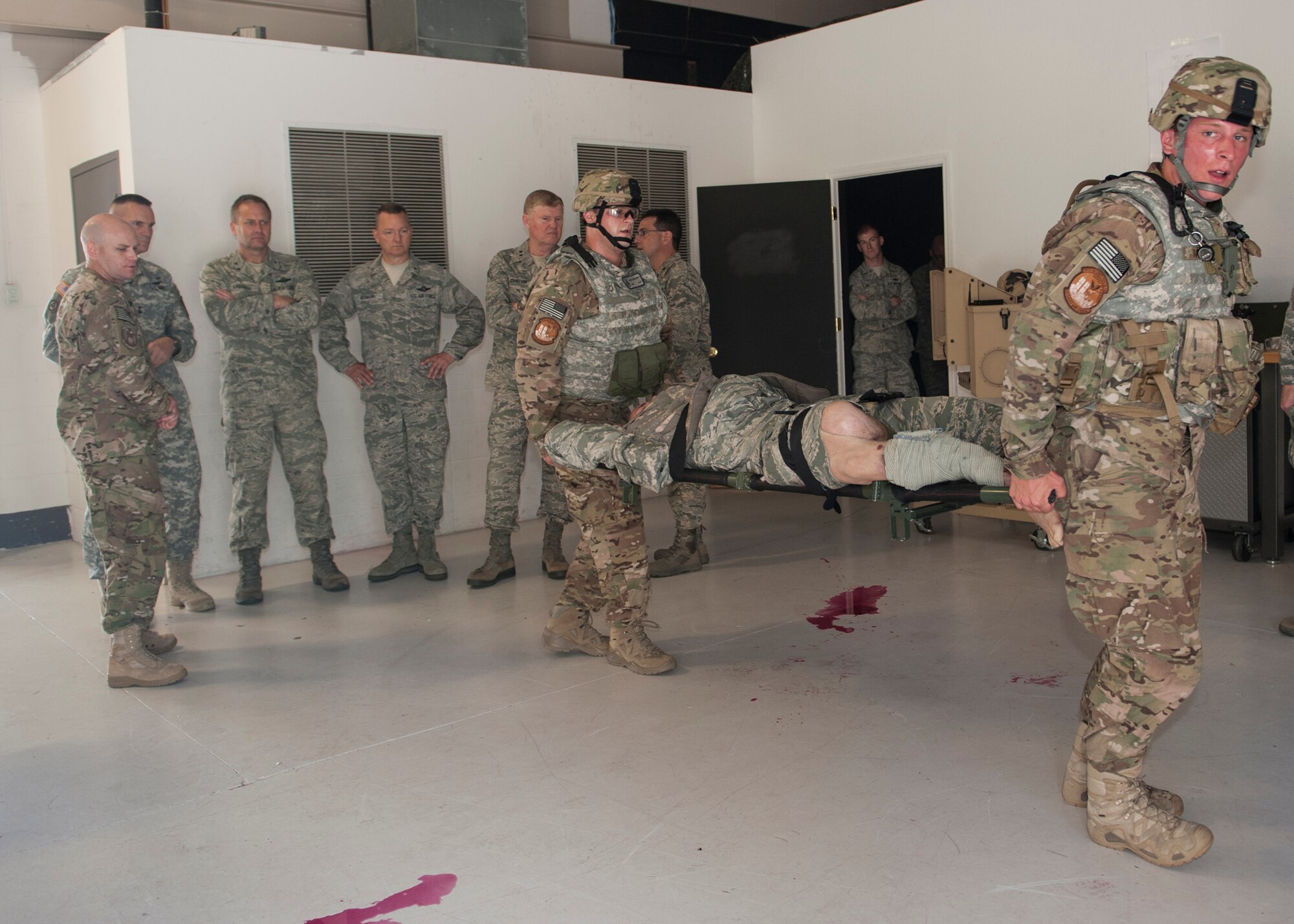 Airmen with the 820th Combat Operations Squadron and 105th New York Air National Guard Security Forces Squadron evacuate a simulated wounded Airman for the 105th SFS leadership training orientation visit at Moody Air Force Base, Ga., June 12, 2013. Since 2009, the 105th SFS has augmented the 820th BDG in training and deployments in an effort to strengthen the Air Force’s combat readiness. (U.S. Air Force photo by Senior Airman Eileen Meier/Released)