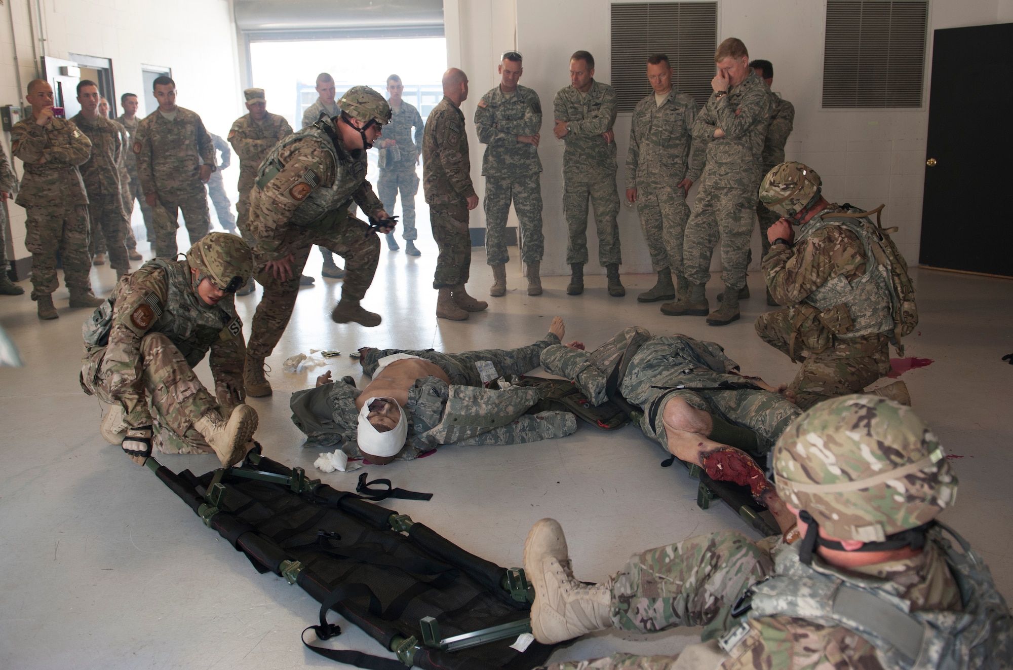 Airmen with the 820th Combat Operations Squadron and 105th New York Air National Guard Security Forces Squadron re-enact a scenario of quickly evacuating wounded people in combat for the 105th SFS leadership visit at Moody Air Force Base, Ga., June 12, 2013. The 105th SFS augments the 820th BDG by training and deploying downrange together, and every three to four years major command members conduct visits to observe the latest training. (U.S. Air Force photo by Senior Airman Eileen Meier/Released)