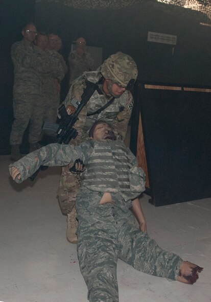 An Airman from the U.S. Air National Guard 105th Security Forces Squadron simulates a medical evacuation for visiting leadership of the 105th SFS headquarters at Moody Air Force Base, Ga., June 12, 2013. The demonstrations are held to inform the unit’s leadership on the latest training and tactical equipment being used in combat. (U.S. Air Force photo by Senior Airman Eileen Meier/Released)
