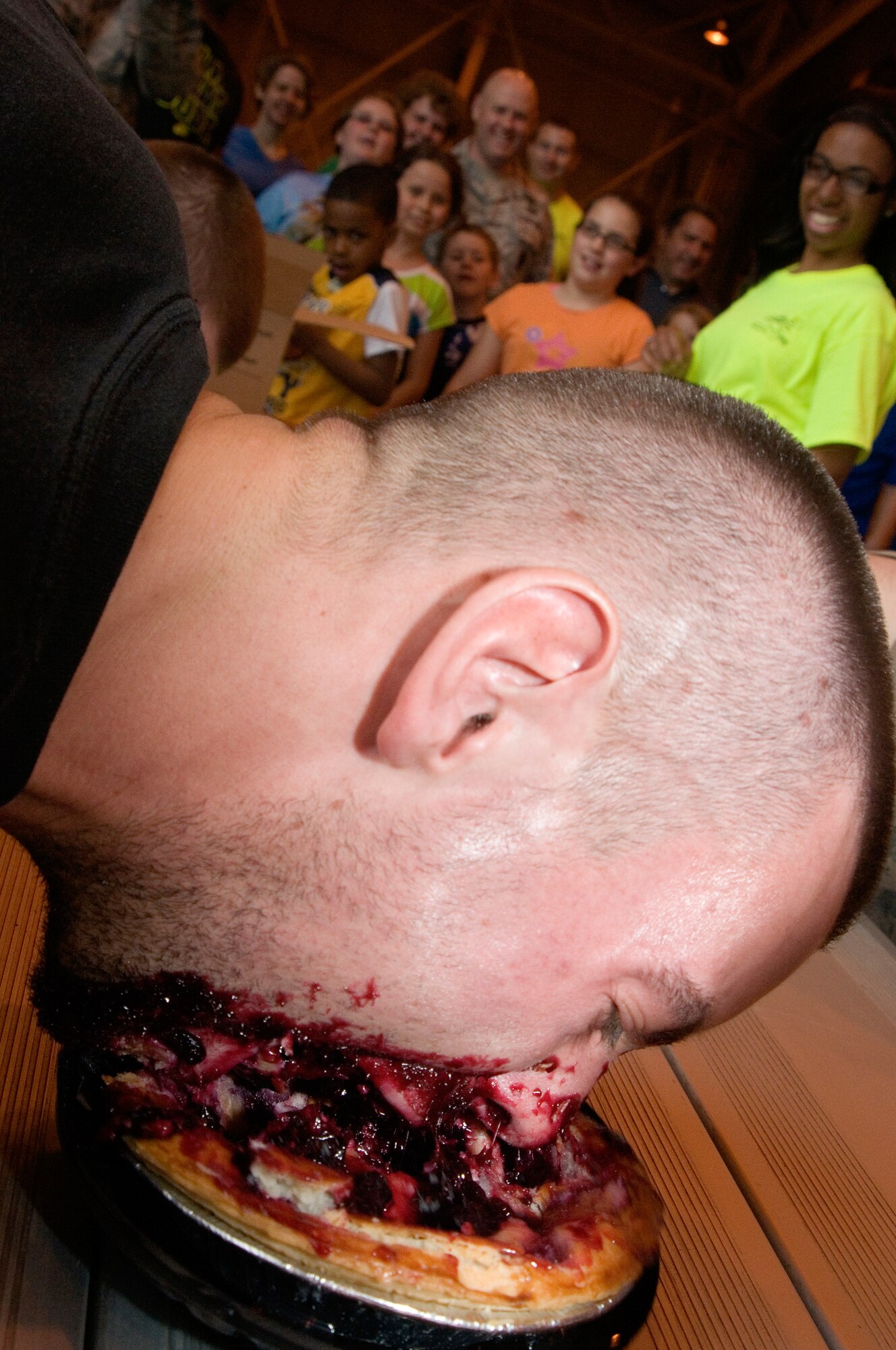 Chris Wiley, 434th Force Support Squadron fitness instructor, takes his bite out of a pie eating contest held during Grissom's Family Appreciation Day here June 1, 2013. Airmen and their families were able to enjoy a number of events and activities during the annual picnic including live music, a rock climbing wall and an inflatable obstacle course. (U.S. Air Force photo/Staff Sgt. Carl Berry)