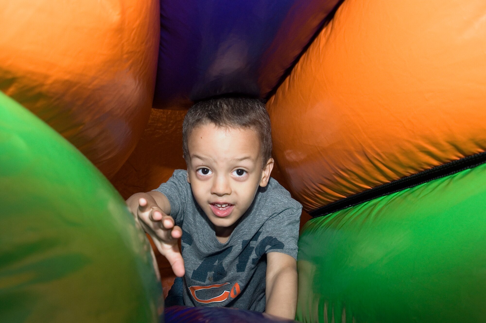 Teagan Hardin crawls through a tunnel on an inflatable obstacle course during Grissom's Family Appreciation Day picnic here June 1, 2013. Teagan is the son of Tech. Sgt. Josh Hardin, 434th Aircraft Maintenance Squadron KC-135 crew chief. (U.S. Air Force photo/Staff Sgt. Carl Berry)