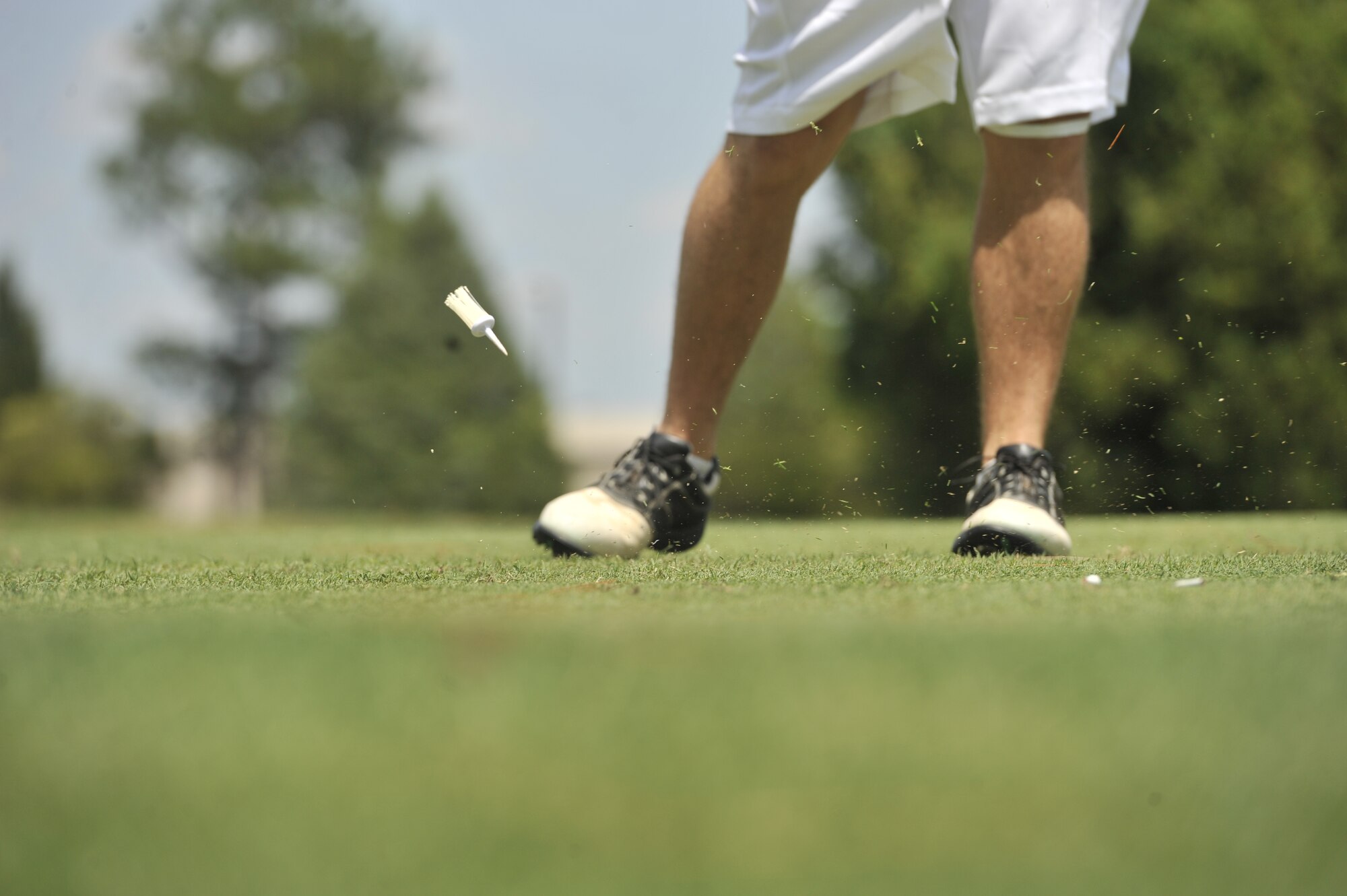 A golfer rips his tee shot and causes his brush tee to fly out of the ground during the Chief’s Group annual golf tournament June 14, 2013, Shaw Air Force Base, S.C. The tournament was open to any golfer who wanted to play. (U.S. Air Force photo by Airman 1st Class Jonathan Bass/Released)