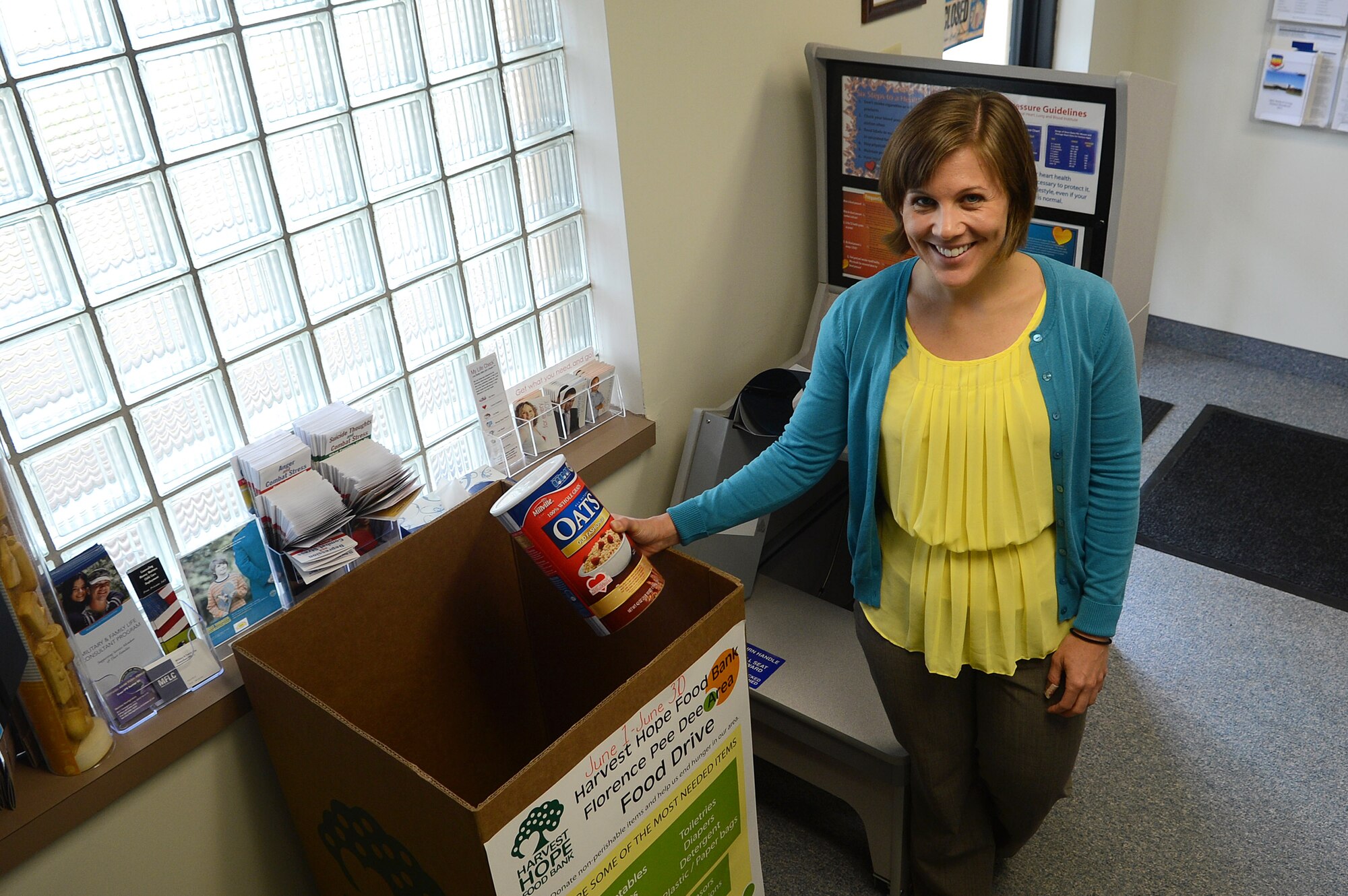 Janine Reinholtz, Health and Wellness Center dietician, places a box of oatmeal into a Harvest Hope food drive bin at Shaw Air Force Base, S.C., June 17, 2013.  Harvest Hope is collecting food from 20 counties in South Carolina to give to the less fortunate. Harvest Hope has food banks in Florence, as well as locations in Columbia and Lexington, S.C., and Greater Greenville, N.C. (U.S. Air Force photo by Airman 1st Class Nicole Sikorski/Released) 