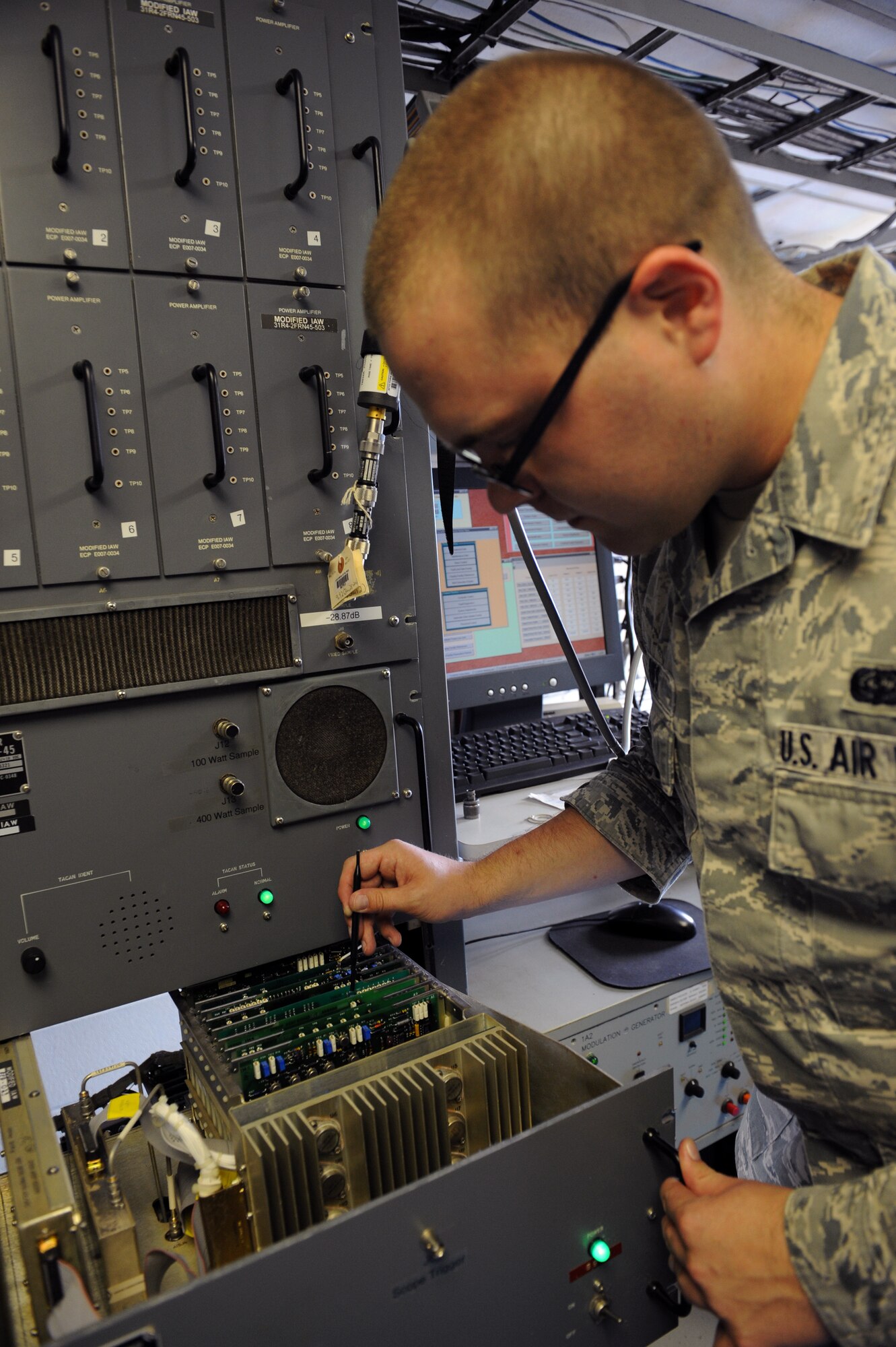 Senior Airman Christopher Ries, 2nd Communications Squadron airfield systems technician, tests the functionality of the tactical air navigation system on Barksdale Air Force Base, La., June 17, 2013. The TACAN tells aircrew personnel how far away they are from Barksdale and is used as a global positioning satellite. (U.S. Air Force photo/Airman 1st Class Benjamin Gonsier)  