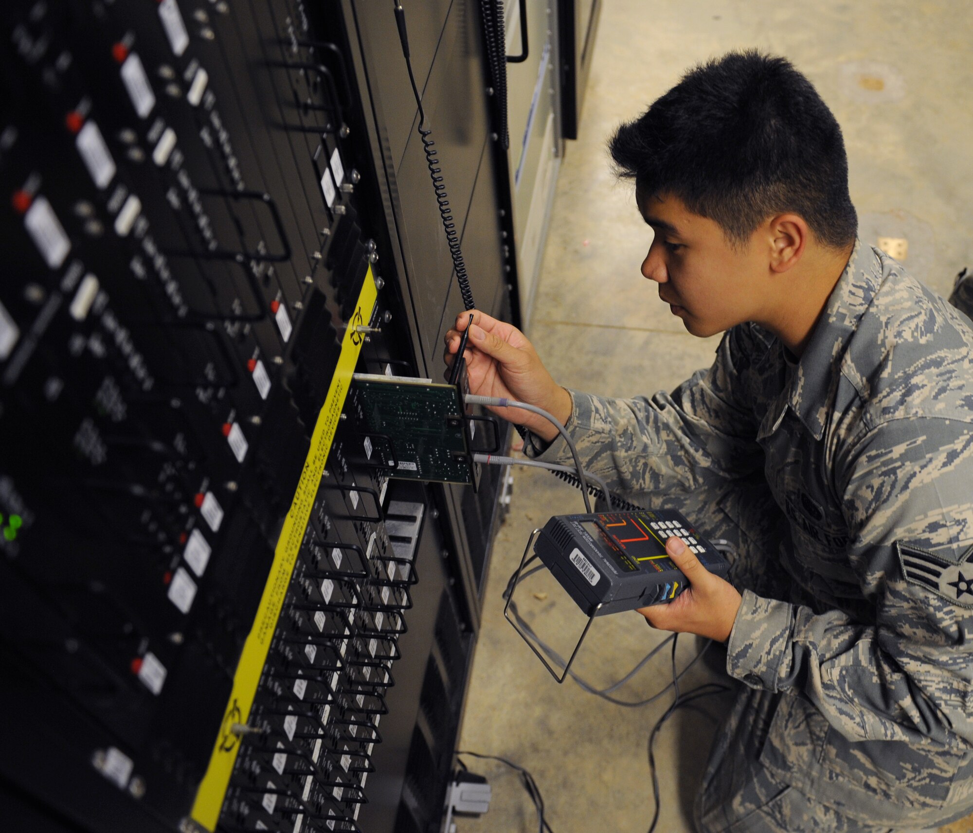 Senior Airman Jeffrey Sales, 2nd Communications Squadron airfield systems technician, uses an AM48 to test the phone line serviceability at the Air Traffic Control tower on Barksdale Air Force Base, La., June 17, 2013. The tower uses its own internal communications systems which 2nd CS airfield systems technicians maintain. (U.S. Air Force photo/Airman 1st Class Benjamin Gonsier)
