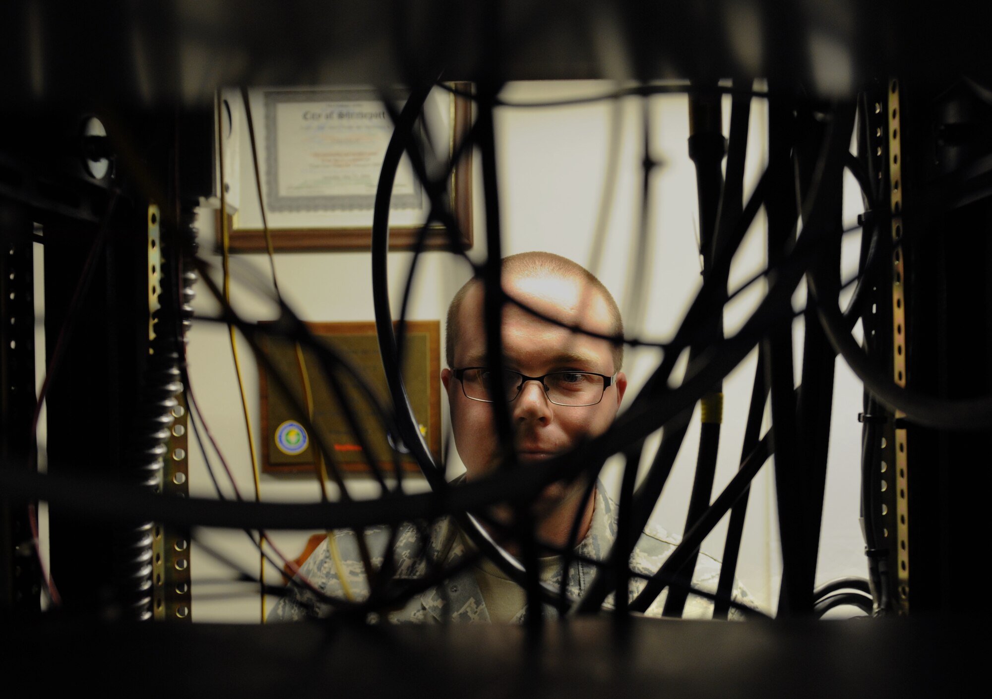 Senior Airman Christopher Ries, 2nd Communications Squadron airfield systems technician, inspects wires for serviceability on Barksdale Air Force Base, La., June 17, 2013. The 2nd CS airfield systems technicians maintain the communication systems which are used to keep aircraft flying in and out of Barksdale. (U.S. Air Force photo/Airman 1st Class Benjamin Gonsier)