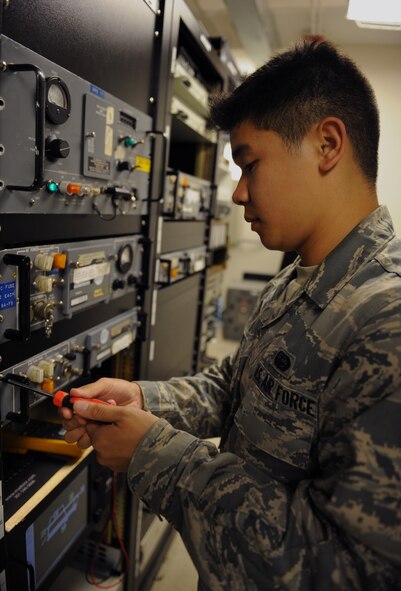 Senior Airman Jeffrey Sales, 2nd Communications Squadron airfield systems technician, unscrews a panel on Barksdale Air Force Base, La., June 17, 2013. The 2nd CS airfield systems technicians maintain the communication systems which are used to keep aircraft flying in and out of Barksdale. (U.S. Air Force photo/Airman 1st Class Benjamin Gonsier) 