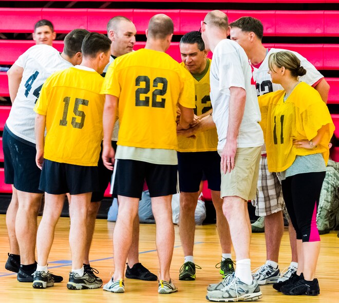 Air Force Office of Special Investigations headquarters members huddle up before a dodge ball match during a Sexual Assault Response and Prevention Wingman Day June 13 at Quantico, Va. (U.S. Air Force Photo/Mike Hastings)