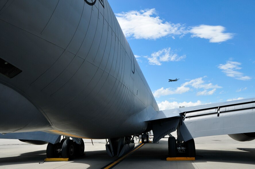 A KC-135R Stratotanker refueling aircraft sits on the ramp as another approaches for landing at McGhee Tyson Air National Guard Base, TN May 3, 2013.  (U.S. Air National Guard photo by Master Sgt. Kendra Owenby/Released)