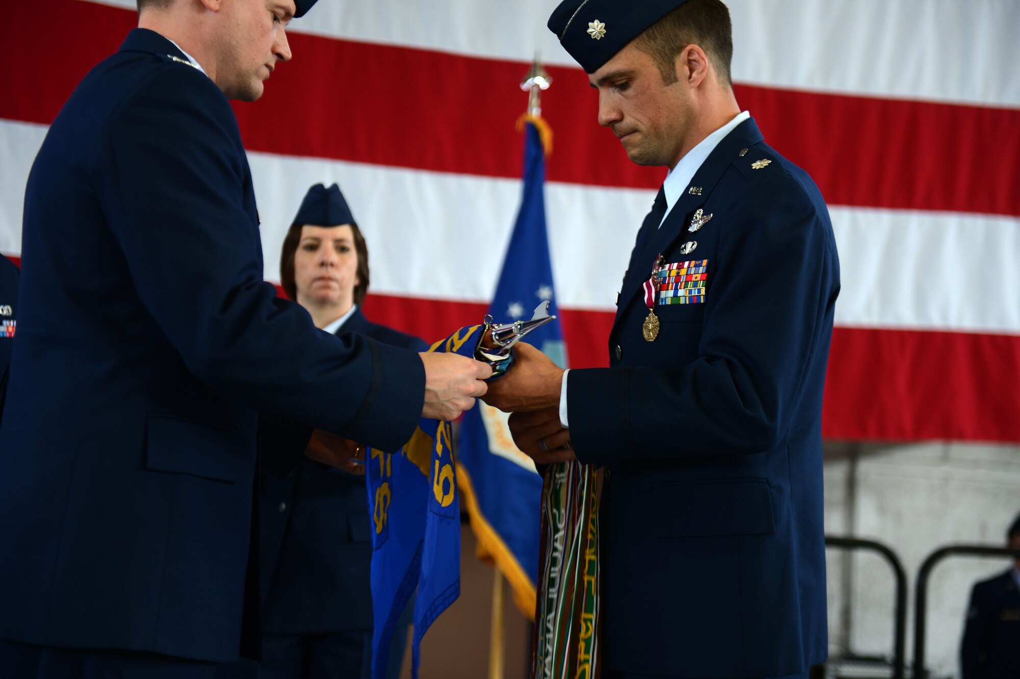 SPANGDAHLEM AIR BASE, Germany – U.S. Air Force Lt. Col. Clint Eichelberger, 81st Fighter Squadron commander, furls the squadron flag during an inactivation ceremony June 18, 2013, at Spangdahlem AB. The rolling and storage of a unit’s guidon honors the tradition and heritage of the Air Force and signifies the closing of a squadron. (U.S. Air Force photo by Airman 1st Class Gustavo Castillo/Released)  
