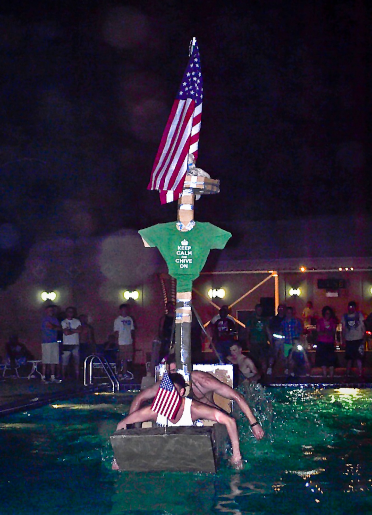 Winning team, “Boats and Hoses," paddle their way to the finish line during the 64th Air Expeditionary Group's First Thursday morale event in Southwest Asia June 6, 2013. (Courtesy photo)