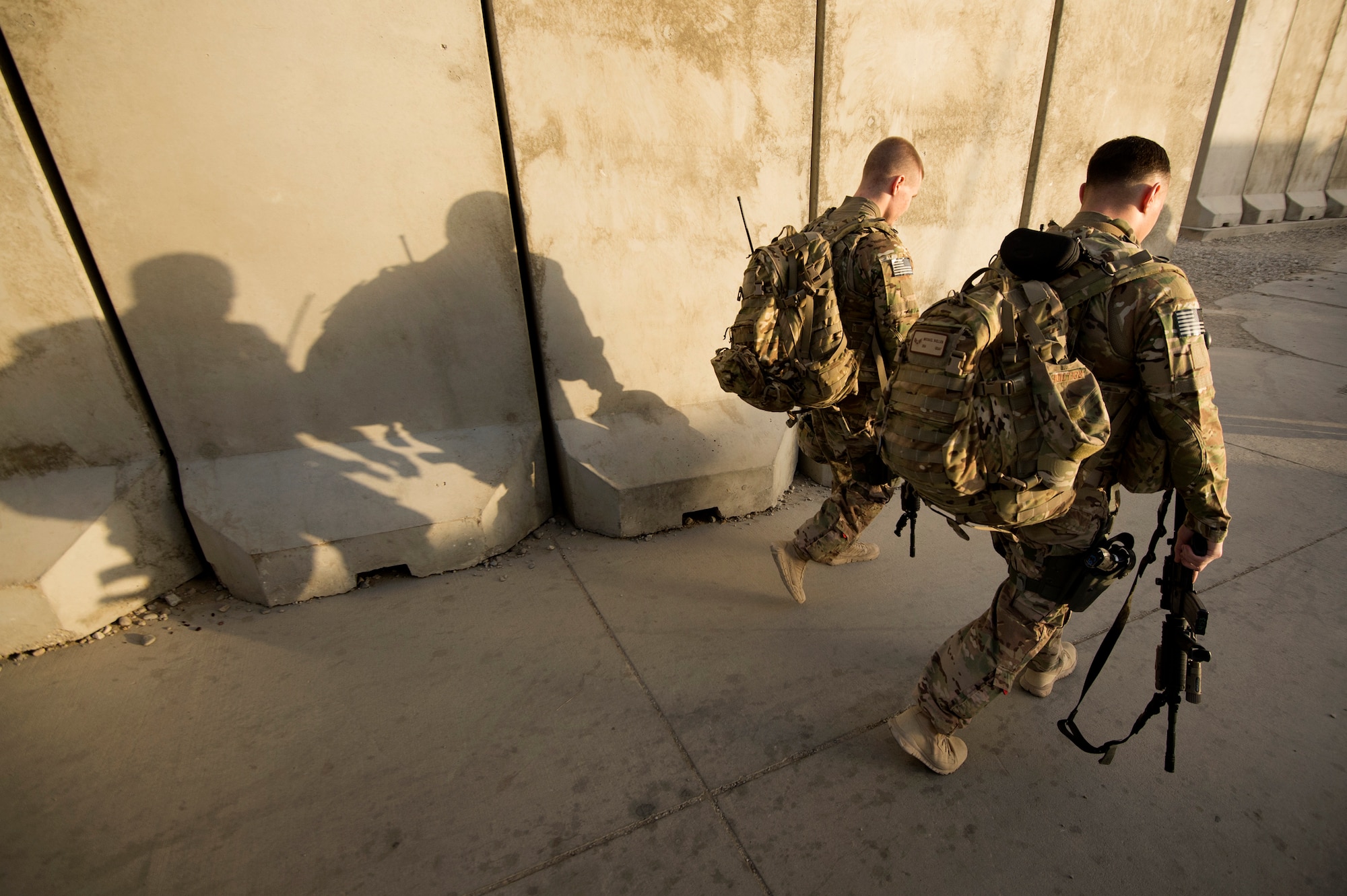 Airman Brandon Gibson and Senior Airman Michael Bullen, 455th Expeditionary Security Forces Squadron Fly-Away Security Team members, step out on a mission that will carry them to several remote locations across Afghanistan June 10, 2013, out of Bagram Air Field. FAST members are required to fly on specific missions when a location requires an extra measure of security to ensure the aircraft and crew are protected from hostile fire or on-board security breaches. Gibson hails from West Fargo, N.D., and Bullen hails from Minot, N.D. Both are deployed from Hector Air Field, North Dakota Air National Guard. (USAF Photo/Master Sgt. Ben Bloker)