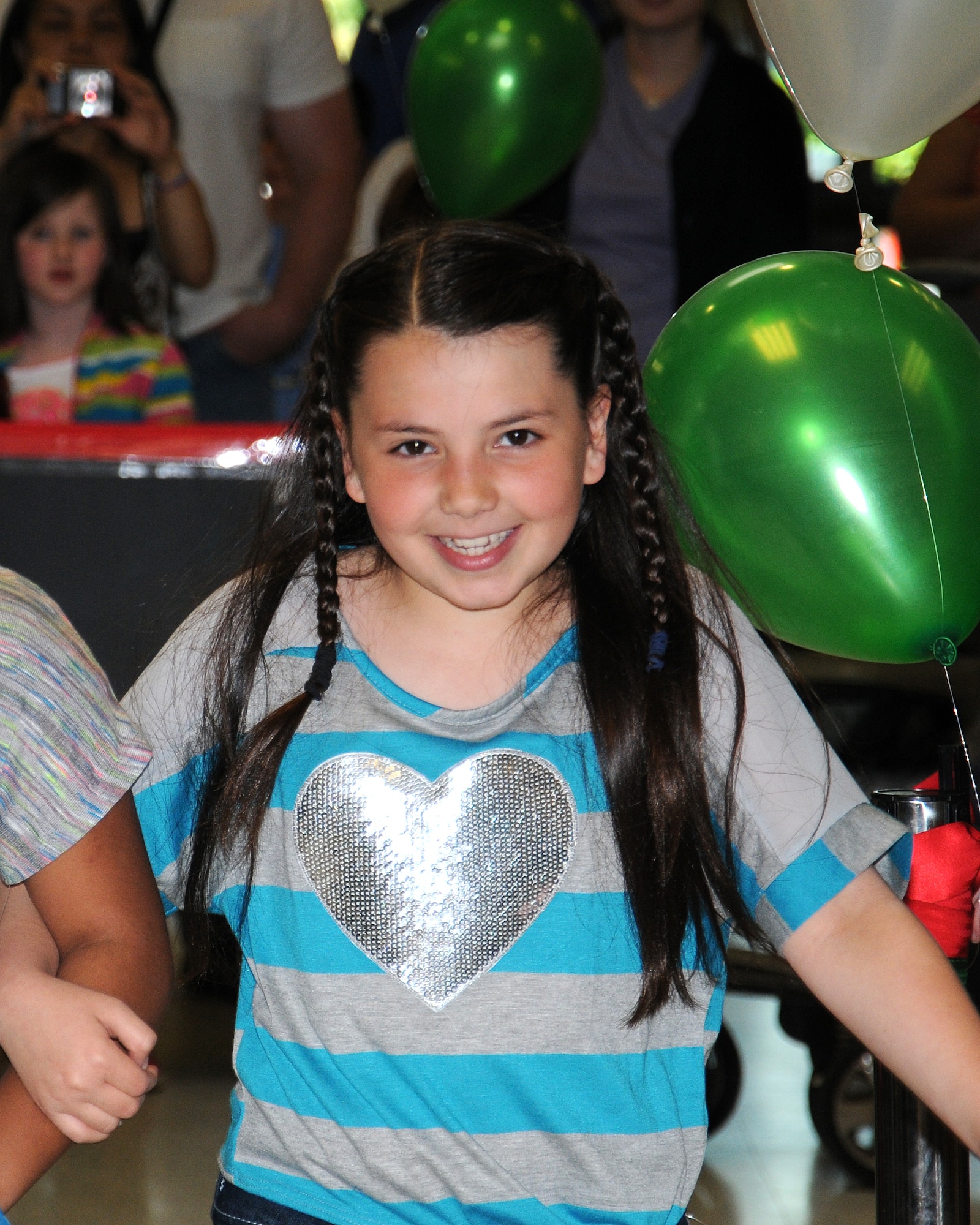 Jade Kuhr, 10, daughter of Joshua Kuhr, 100th Force Support Squadron chief resource manager from Bloomington, Minn., takes part in a charity fashion show June 14, 2013, at RAF Lakenheath, England. Models for the fashion show included Girl Scouts and Cub Scouts of various age groups. The girls chose to plan and host a fashion show in order to collect clothing donations for several local charities as well as for the Majengo Children's Home in Tanzania. (U.S. Air Force photo by Gina Randall/Released)