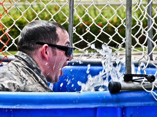 Master Sgt. KC Smith, 36th Contingency Response Group first sergeant, emerges from the dunk tank June 14, 2013, on Andersen Air Force Base, Guam, during a Dorm Dweller and Deployer Appreciation day event. The day’s festivities included a flag football tournament, open use of the base pool, a giant slip and slide, corn-hole toss, ladder golf, hula dance performances, K-9 demonstrations and a first sergeant and commander dunk tank. (U.S. Air Force photo by Airman 1st Class Marianique Santos/Released)